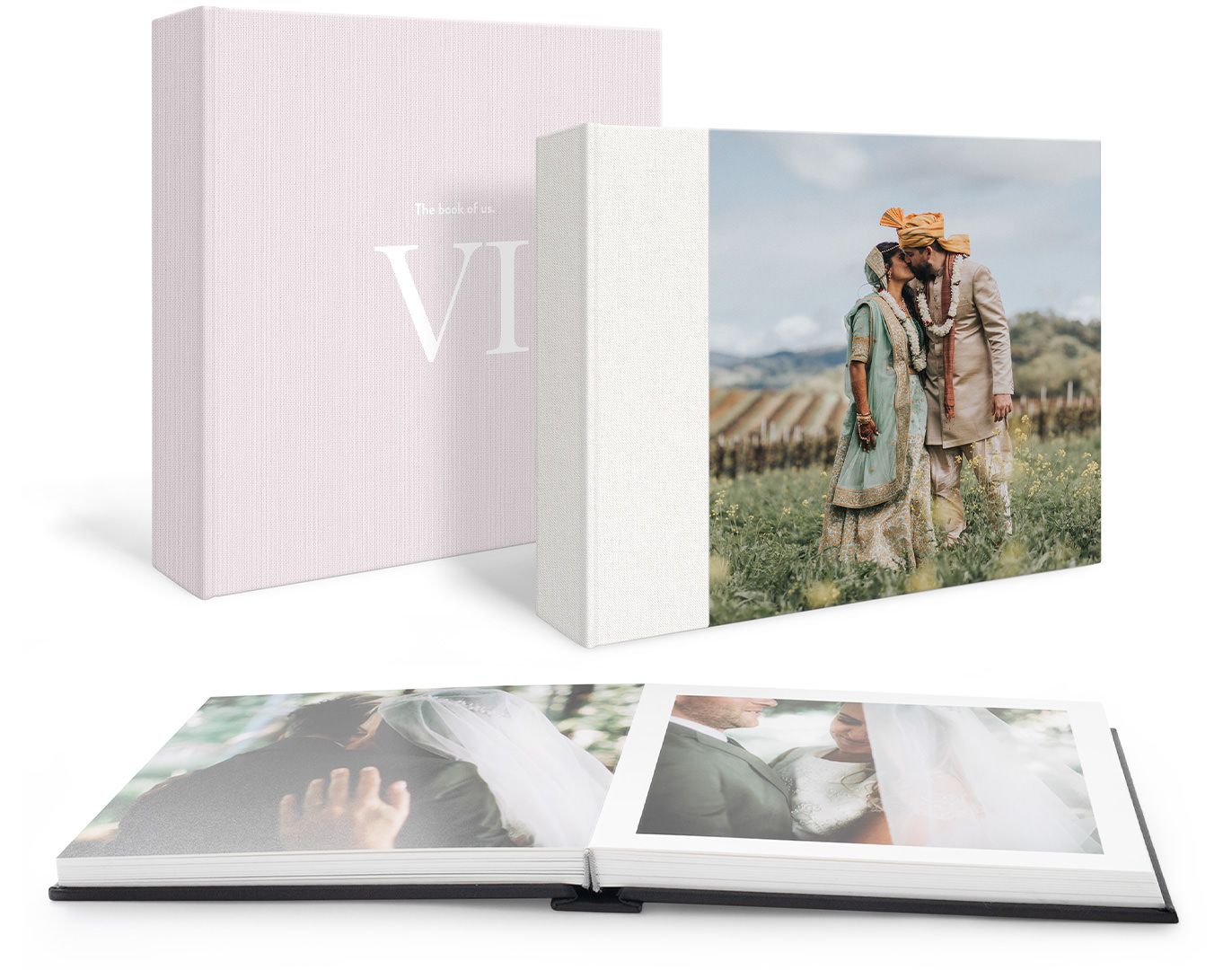 Two standing premium photo albums; text only on one cover, and a couple on their wedding on the other. And an open photo album in the foreground with portrait images of a couple on their wedding day.