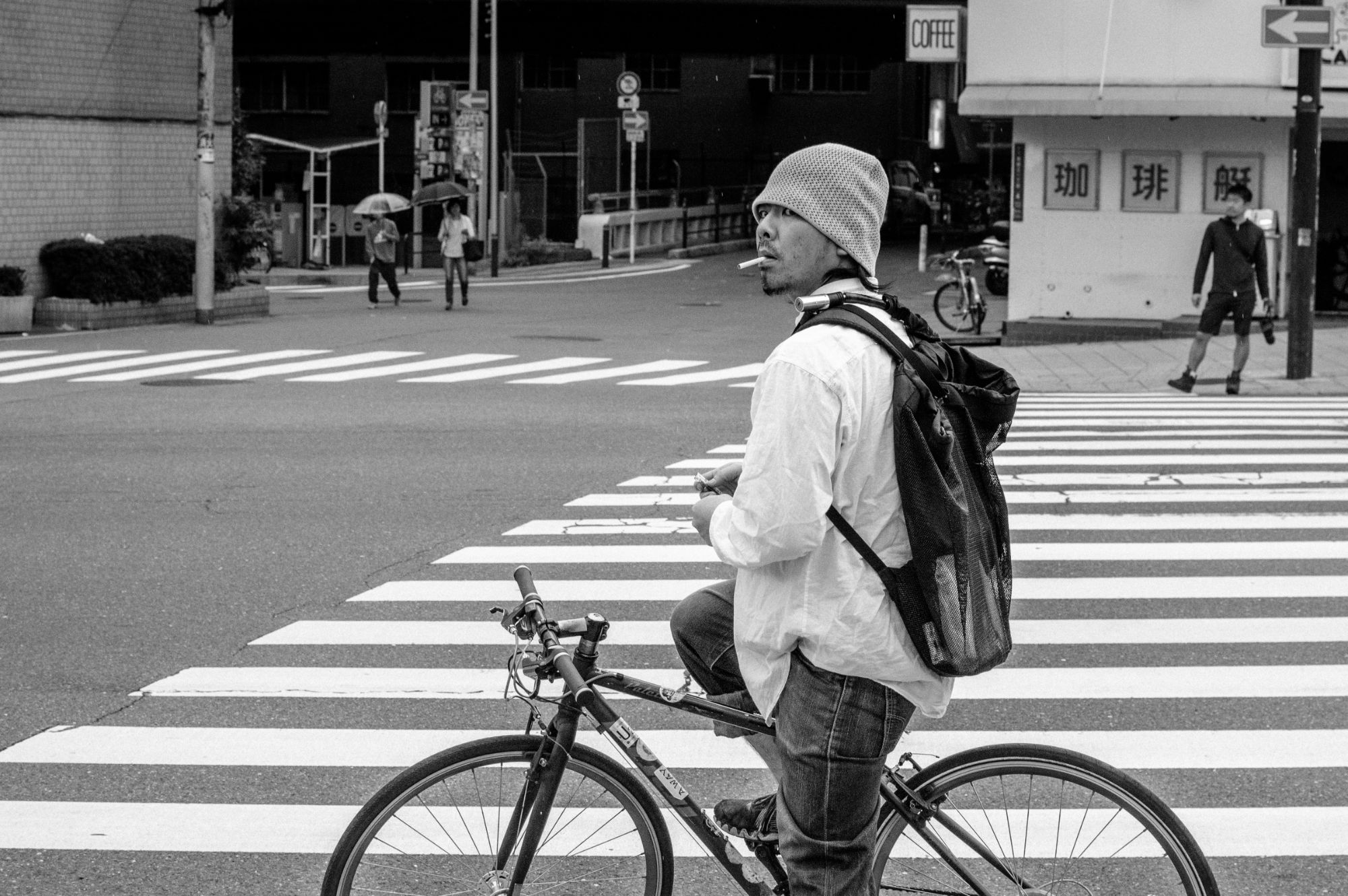 Man riding bike with cigarette in mouth