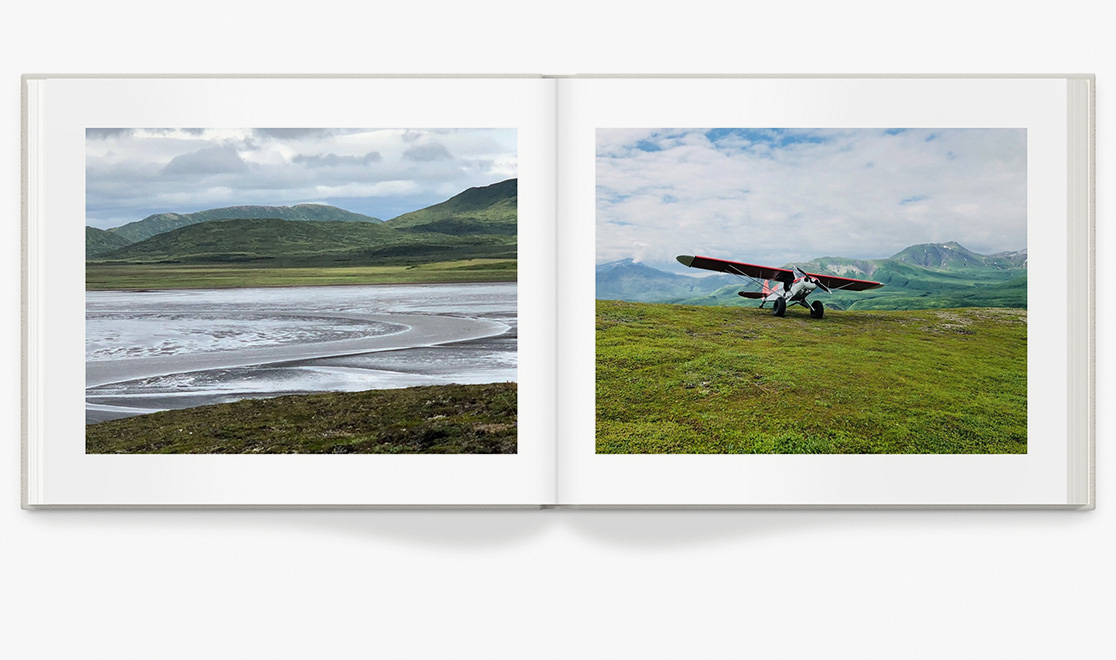 Open photo book with landscape photography.