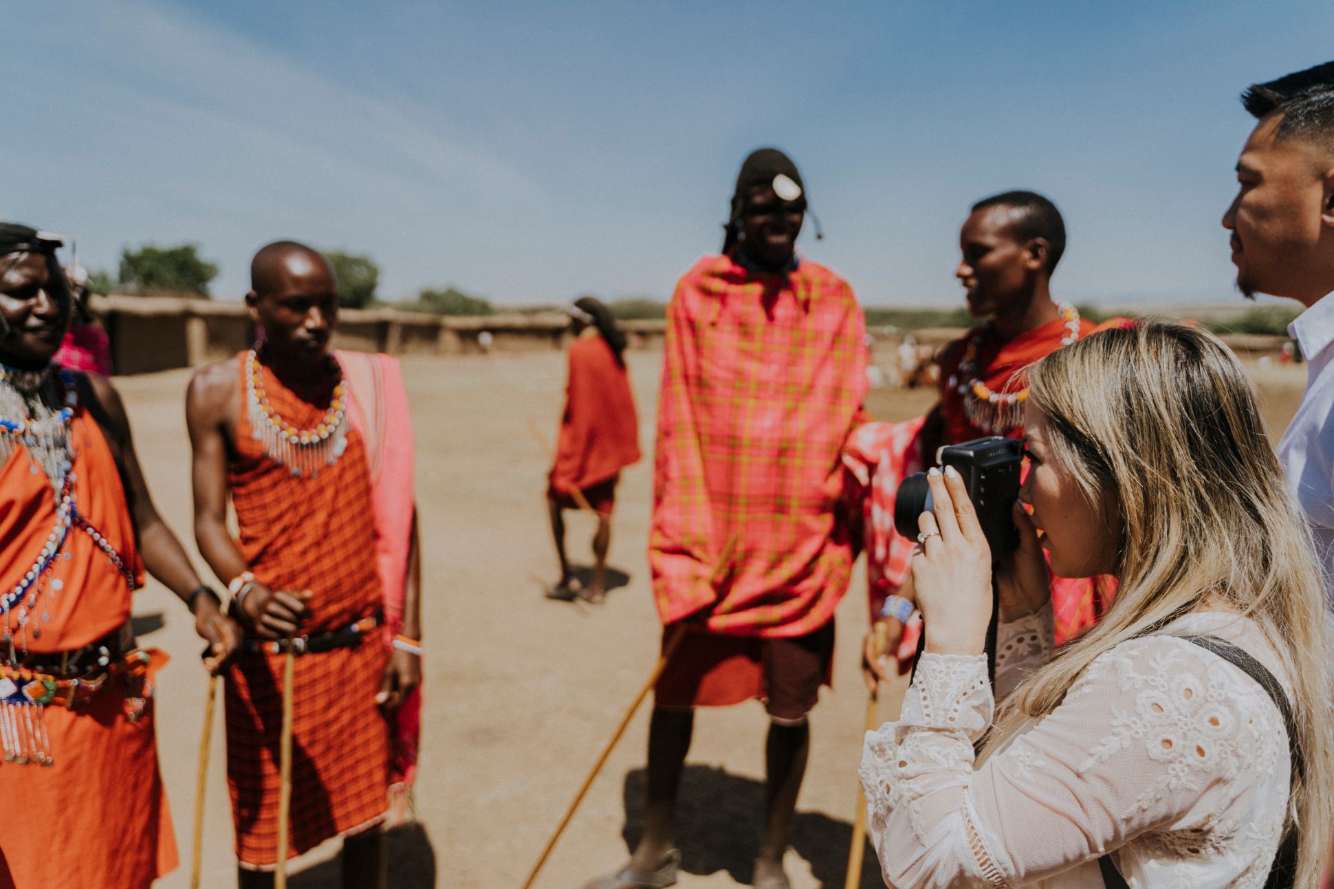 Woman taking photo of local Kenyans