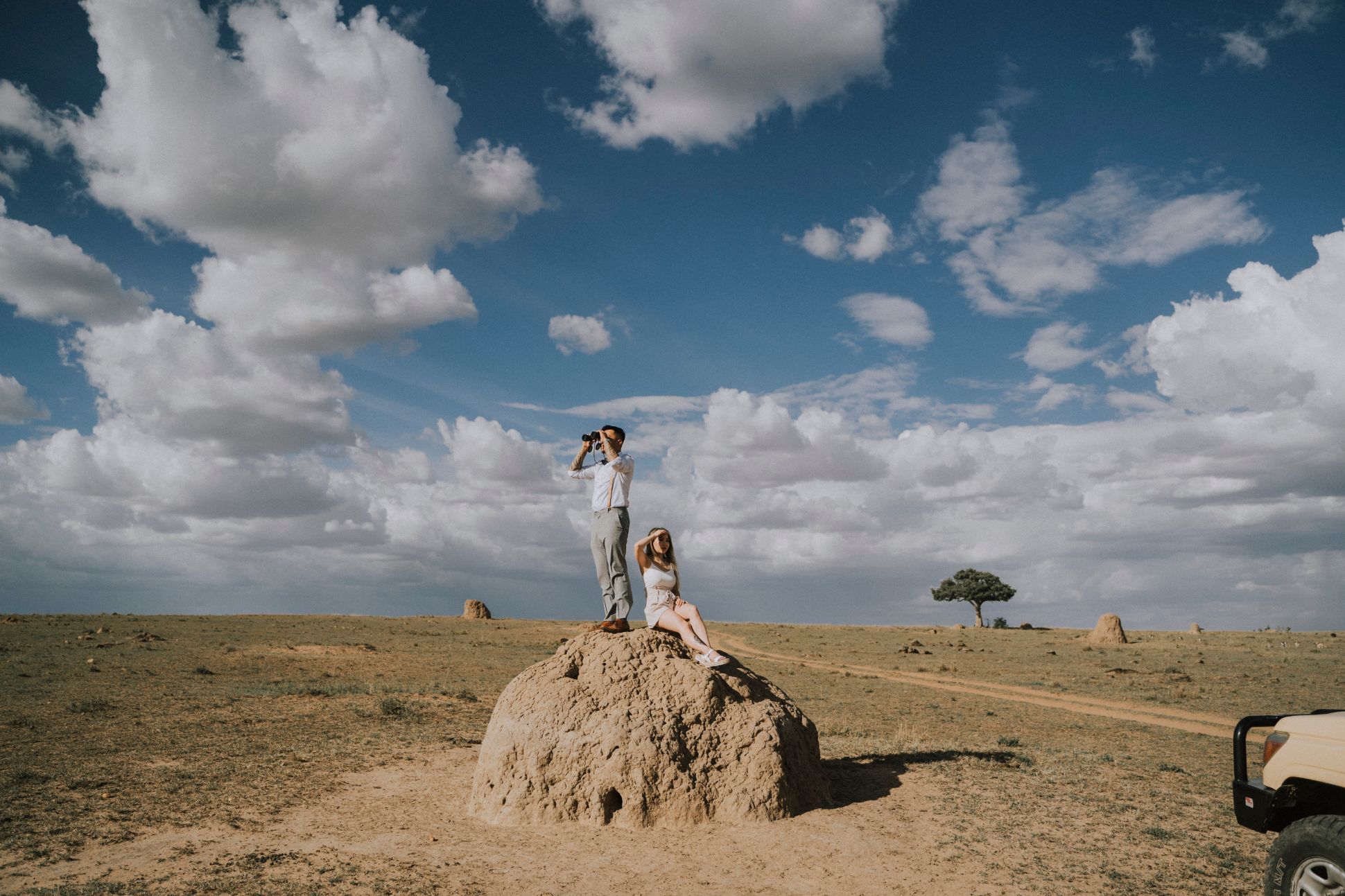 Man and woman looking out on rock