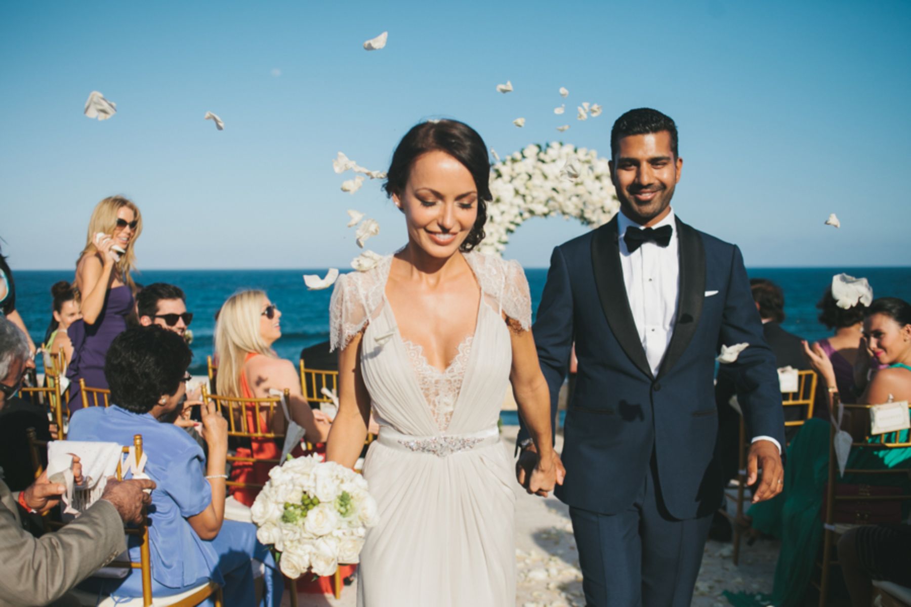 Newlywed couple walking back down the aisle together