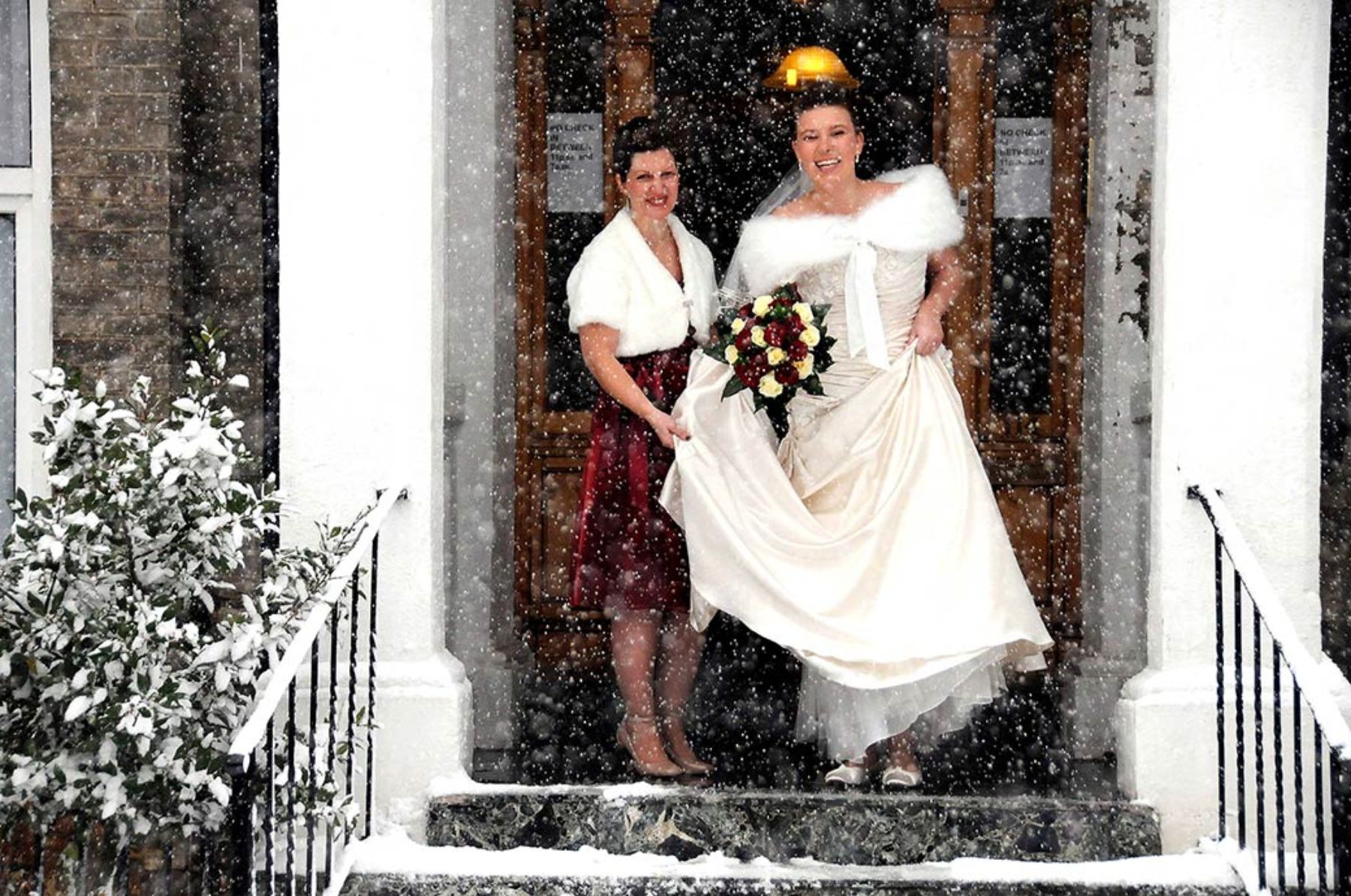 Bride holding flower bouquet in snow