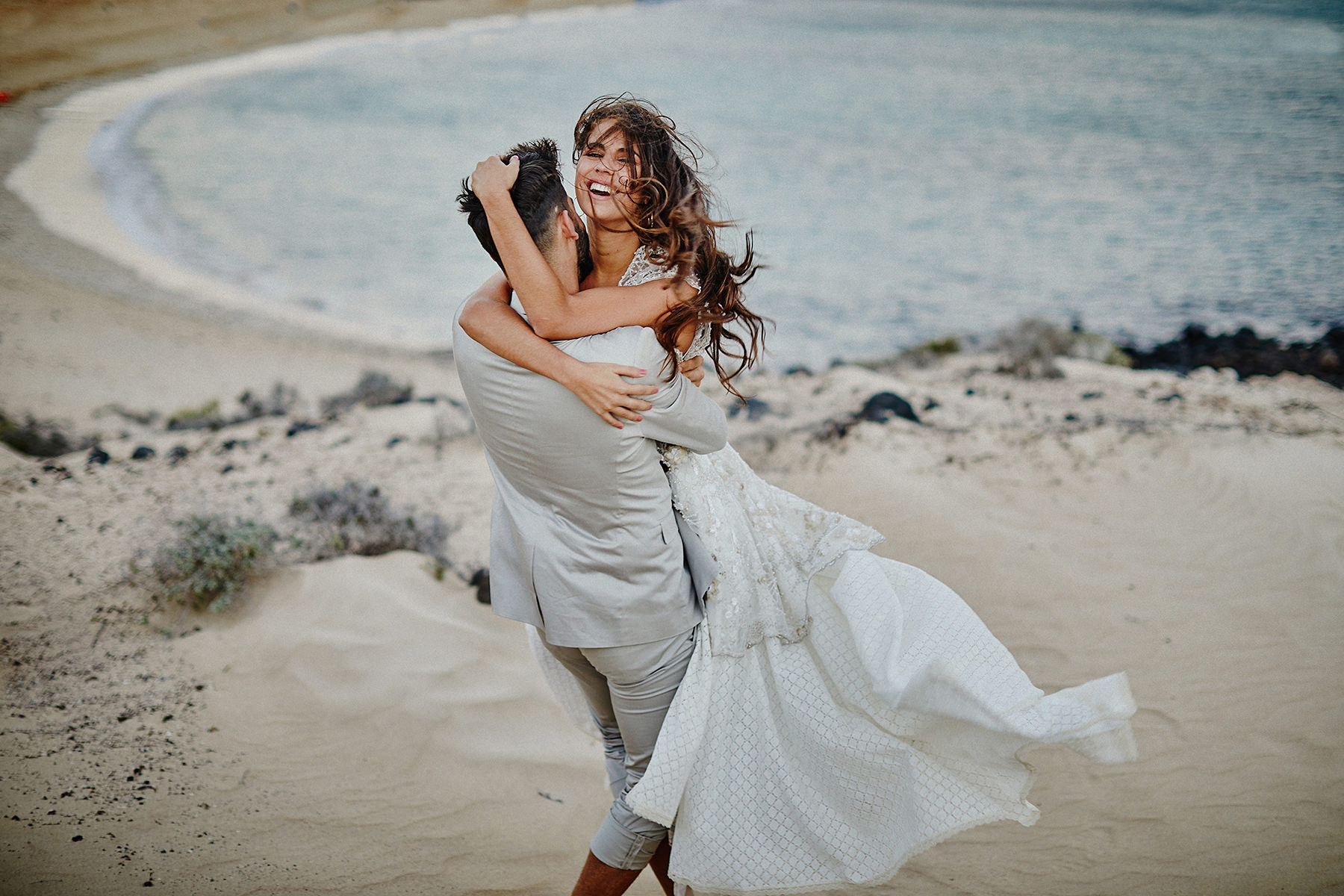 Newlywed couple embracing on the sea shore