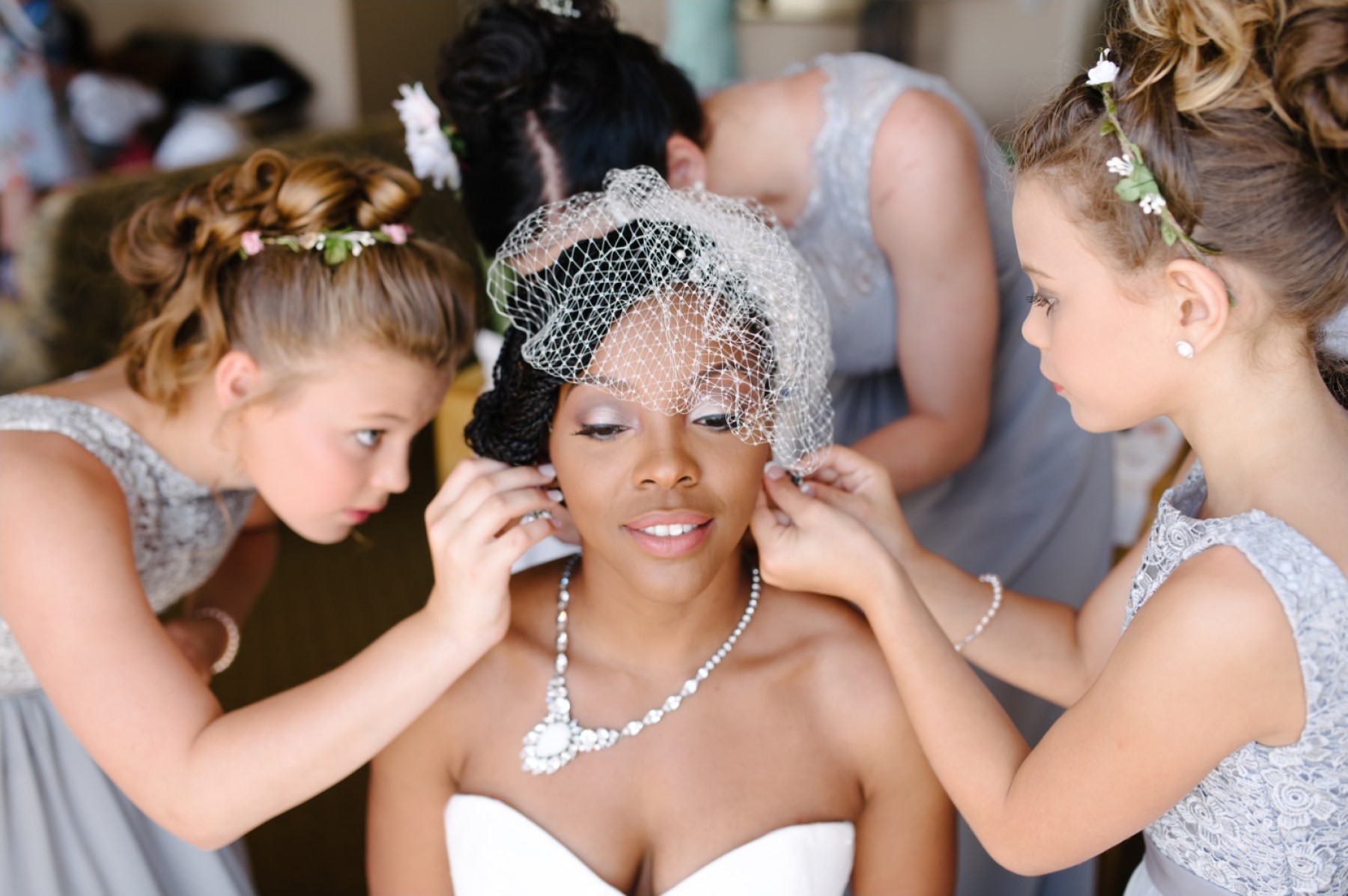 Young girls helping bride get ready