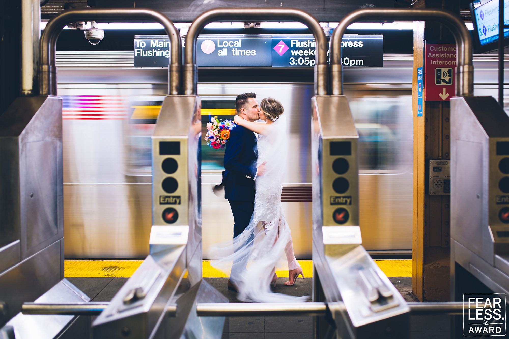 Newlywed couple kissing in train station