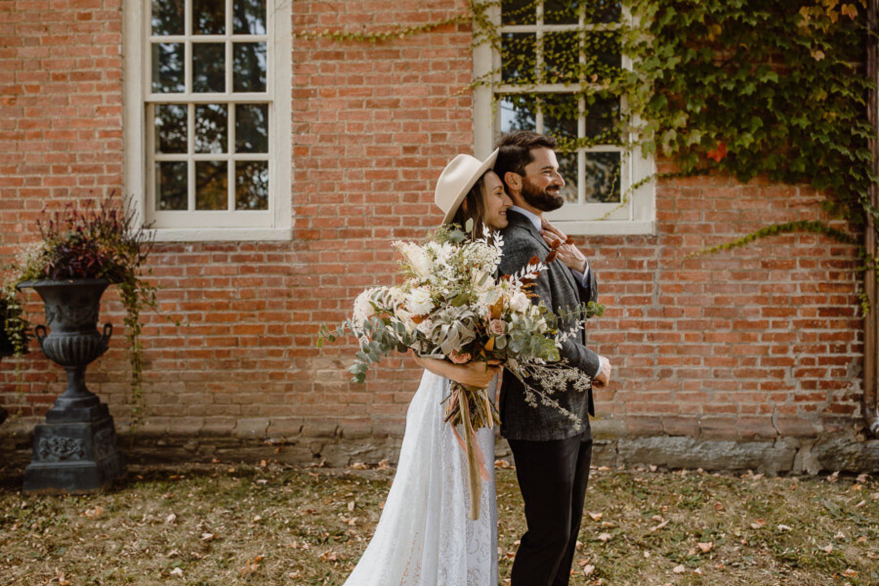 Bride and groom posing in leaves