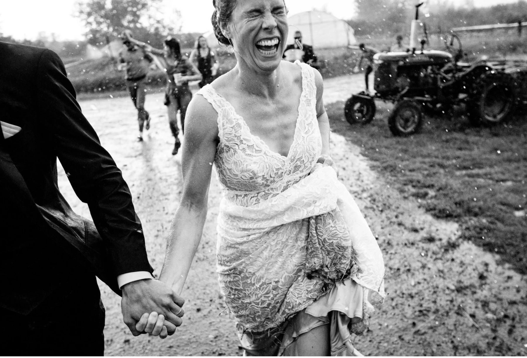 Bride and groom running to escape the rain
