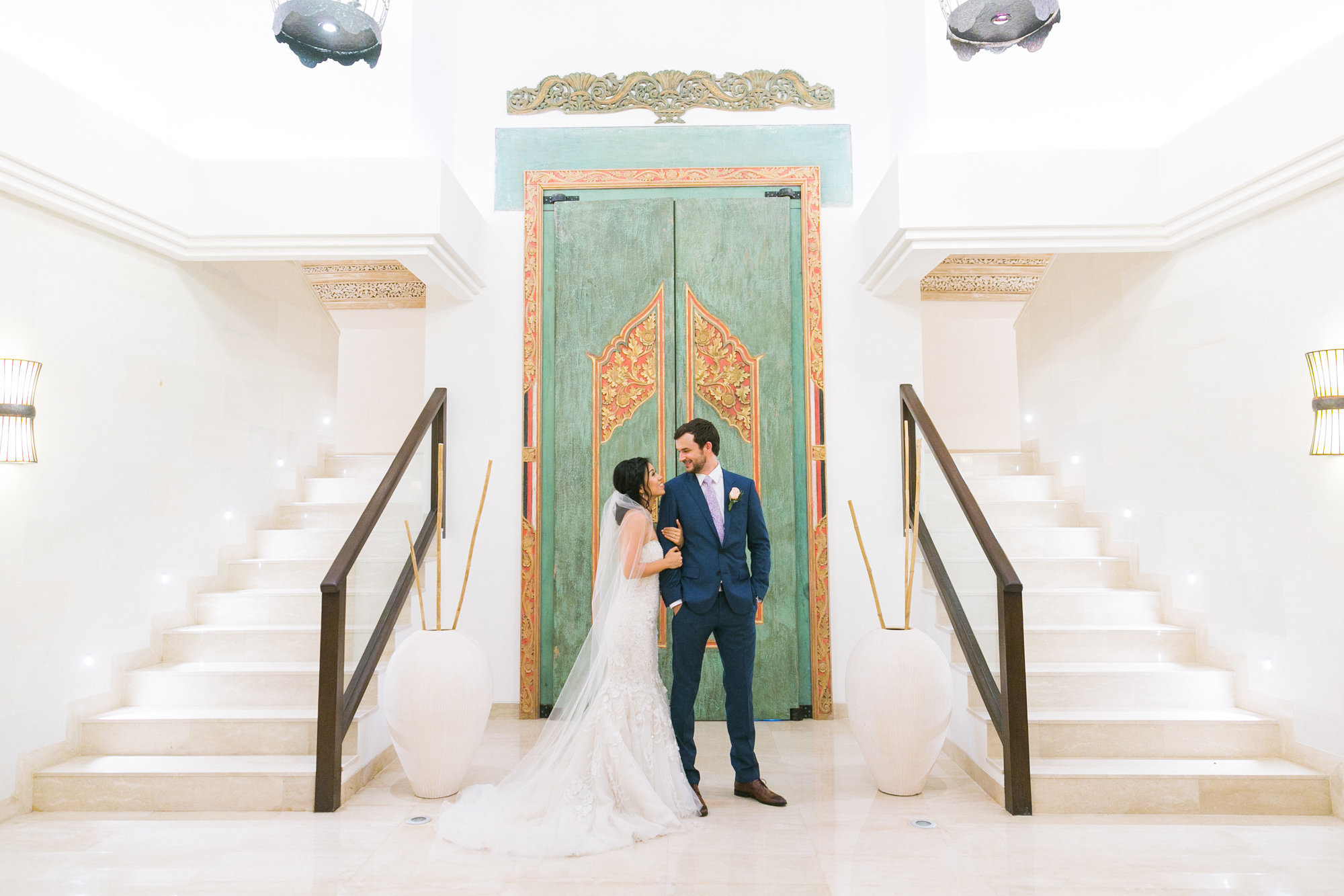 Newlyweds gaze at each other in foyer