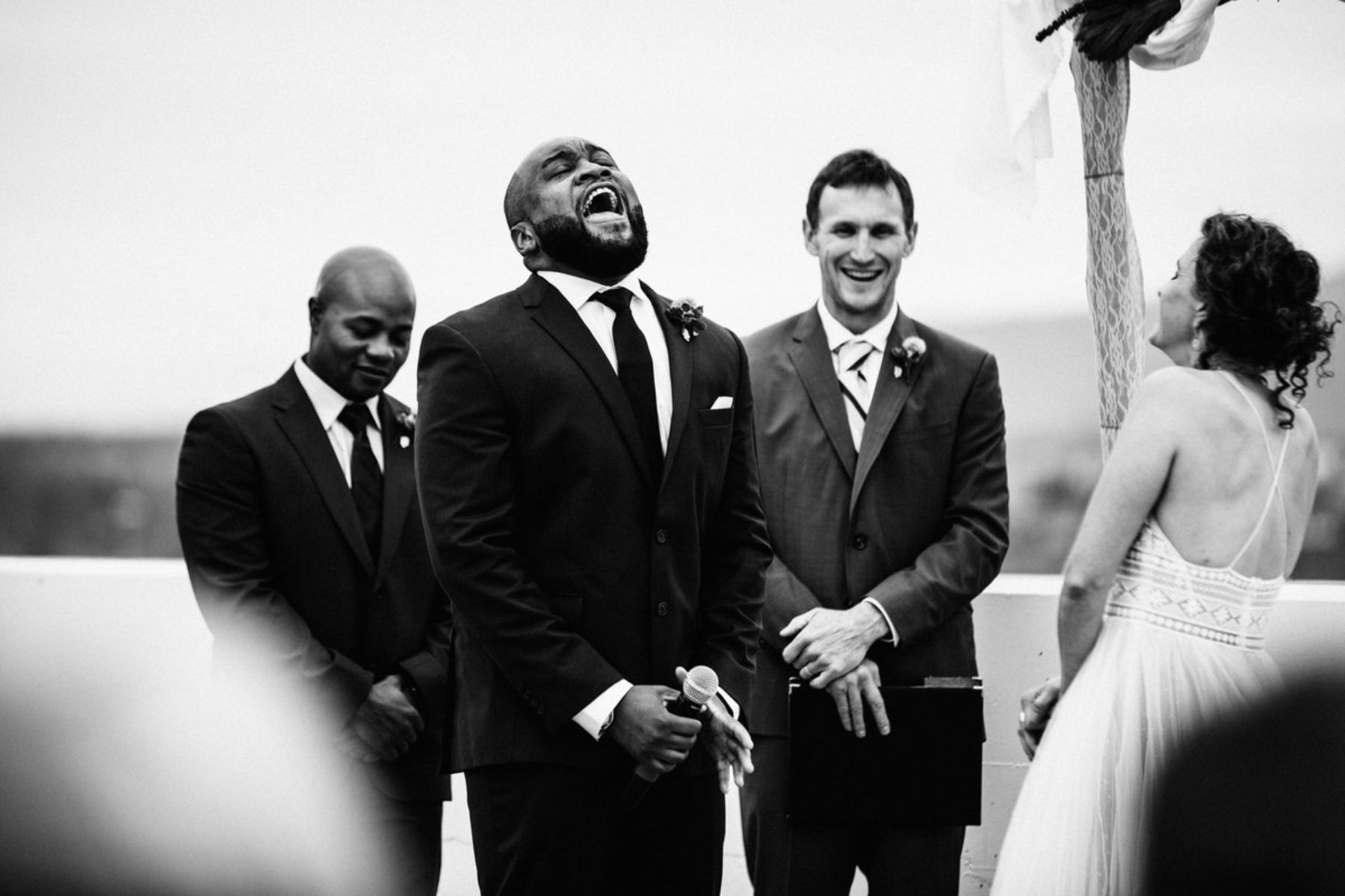 Groom laughing at altar