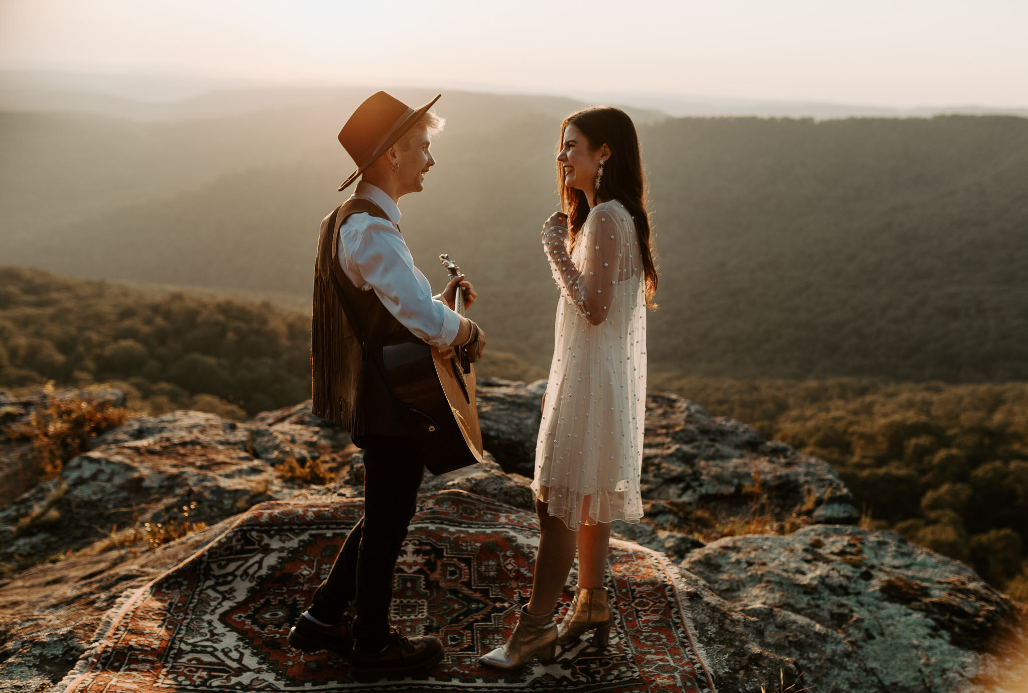 Groom playing guitar for bride