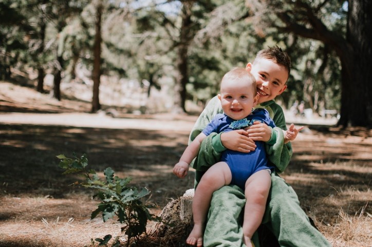 Young child and baby in park