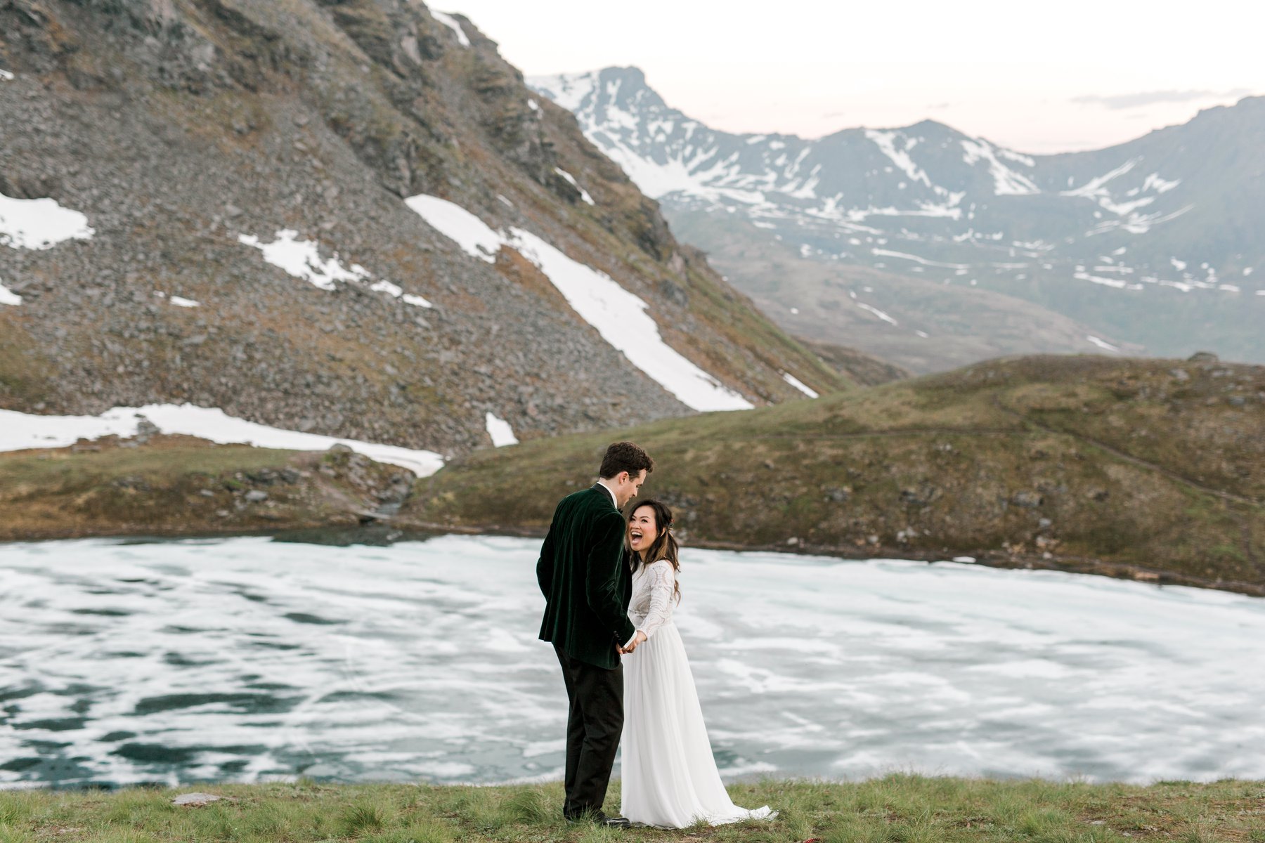 Bride and groom smiling in icy landscape
