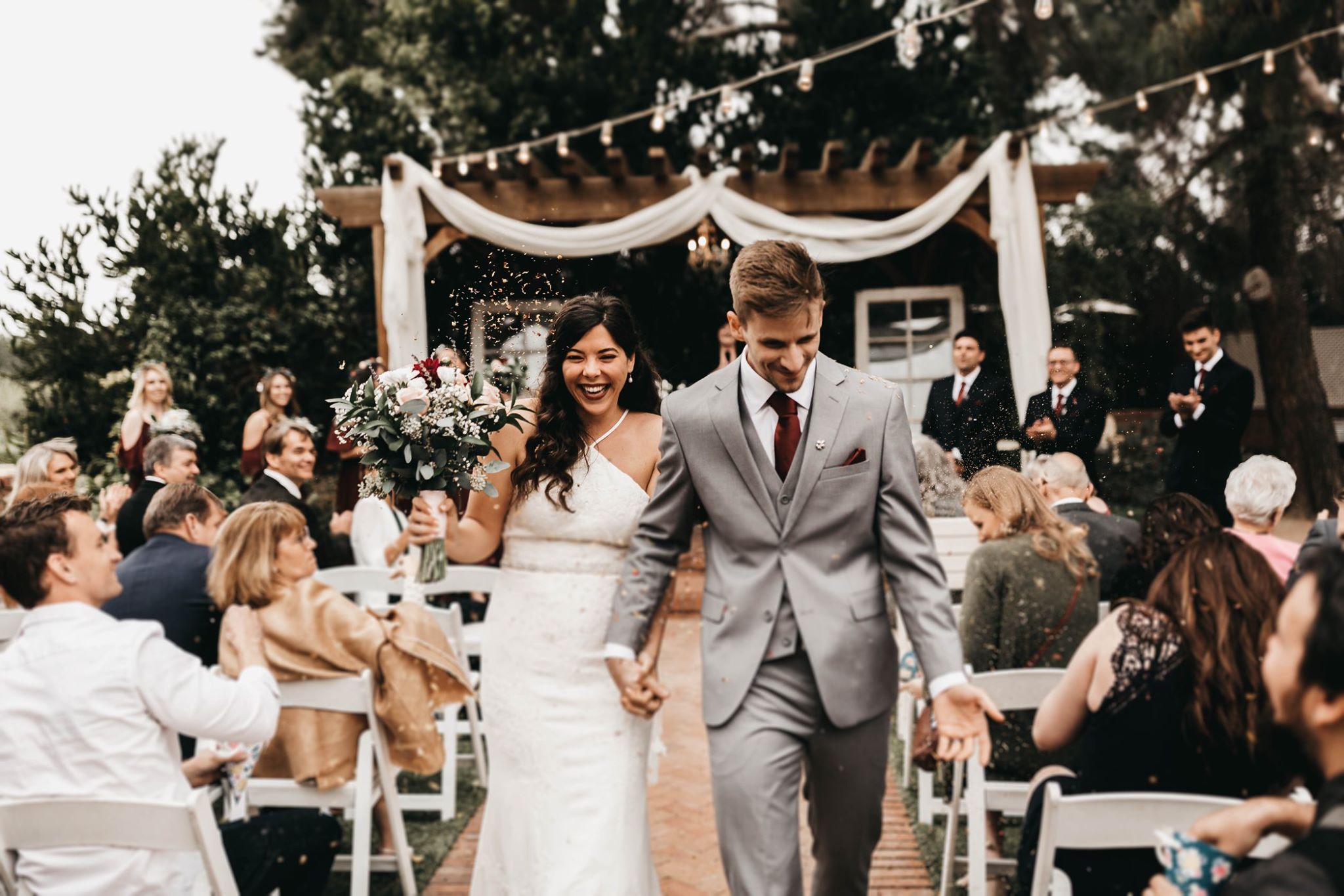 Newlyweds walking back down the aisle together smiling