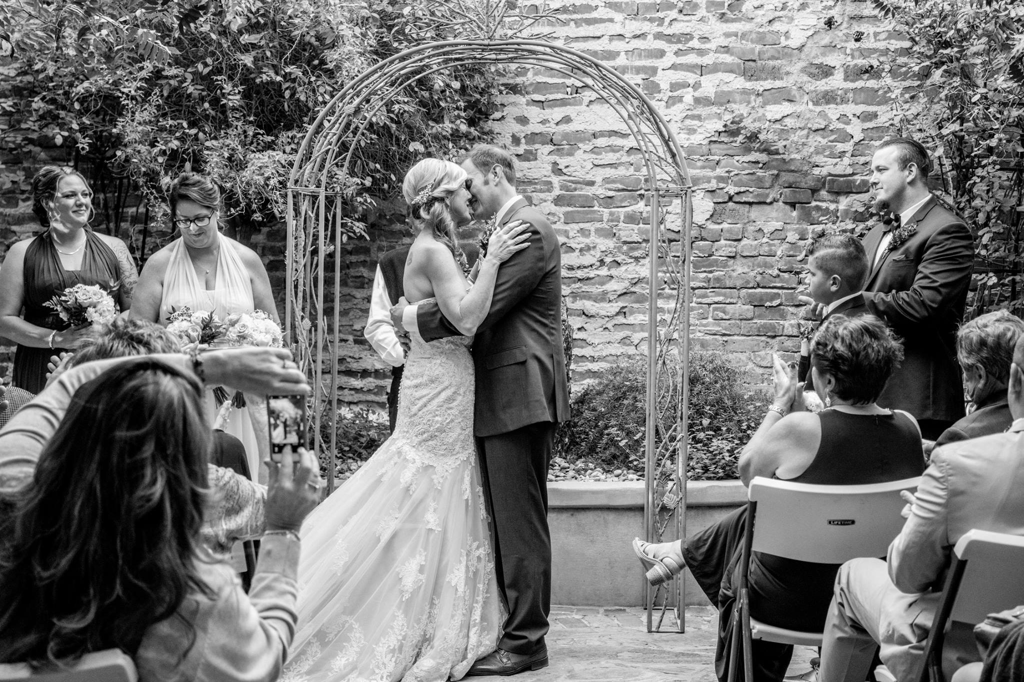Bride and groom kiss at altar