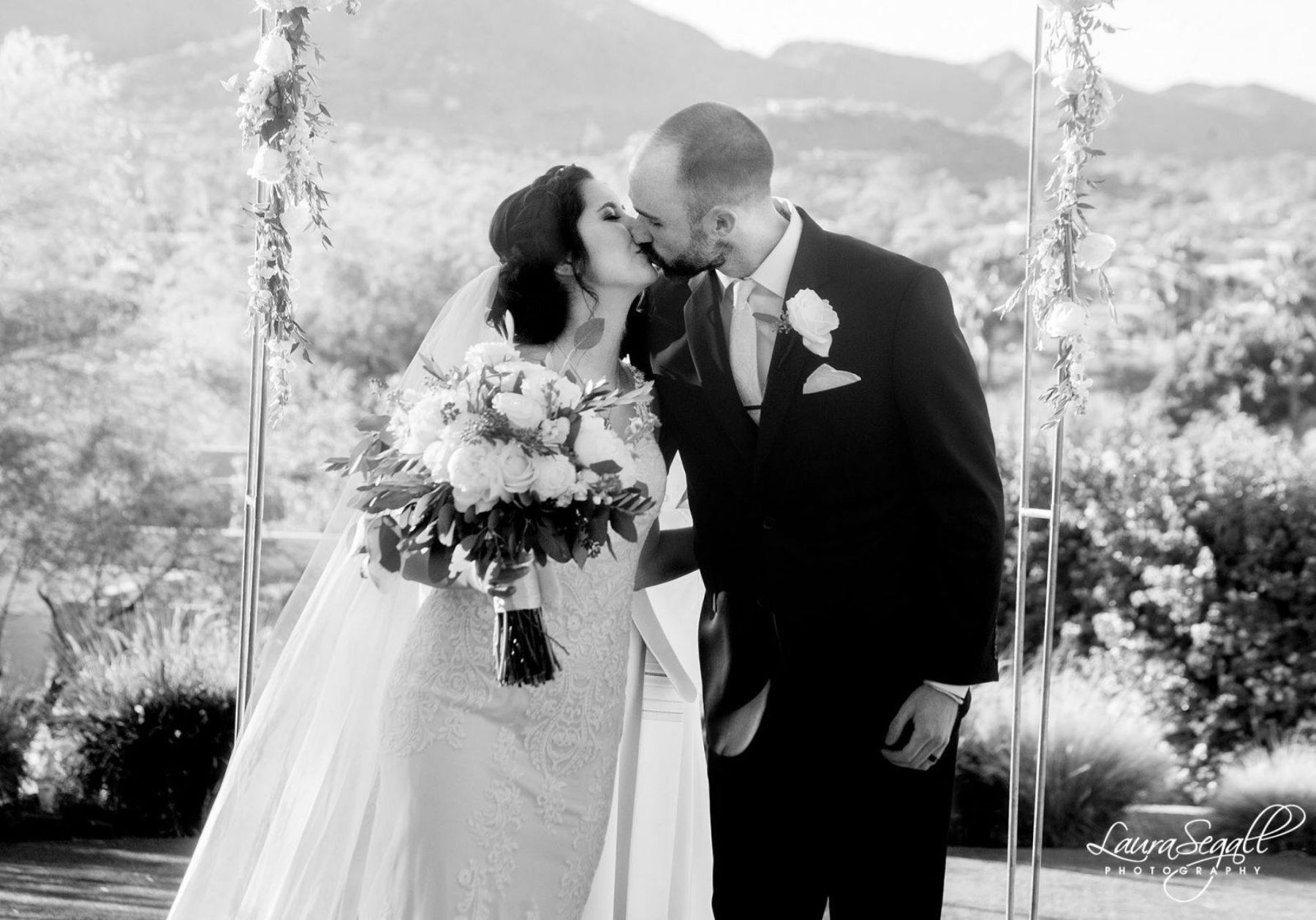 Bride and groom kiss at altar