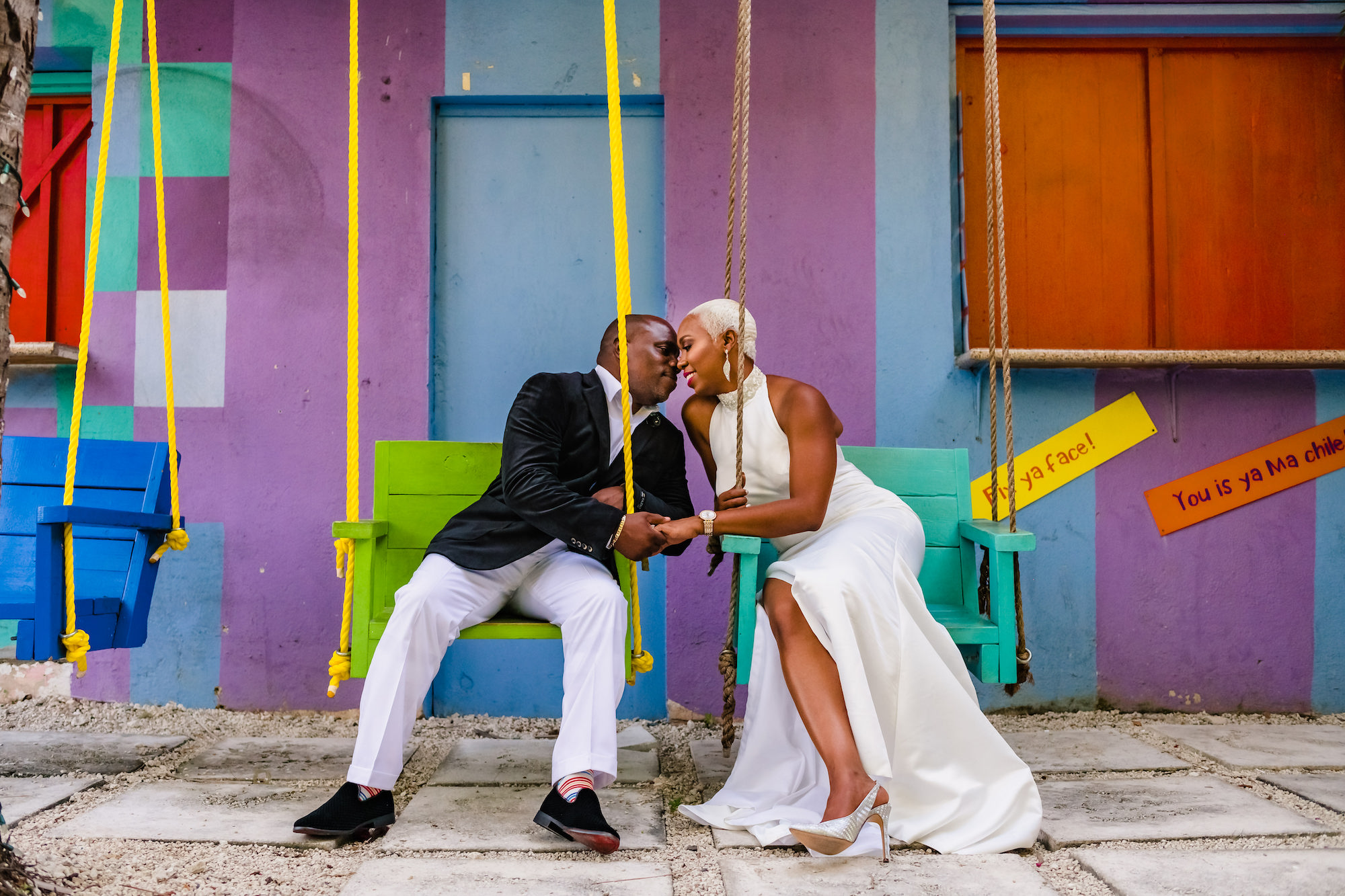 Newlywed couple on swings kissing