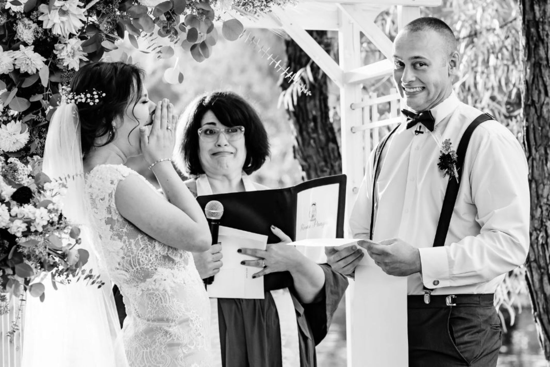 Bride laughing as groom shares vows at altar