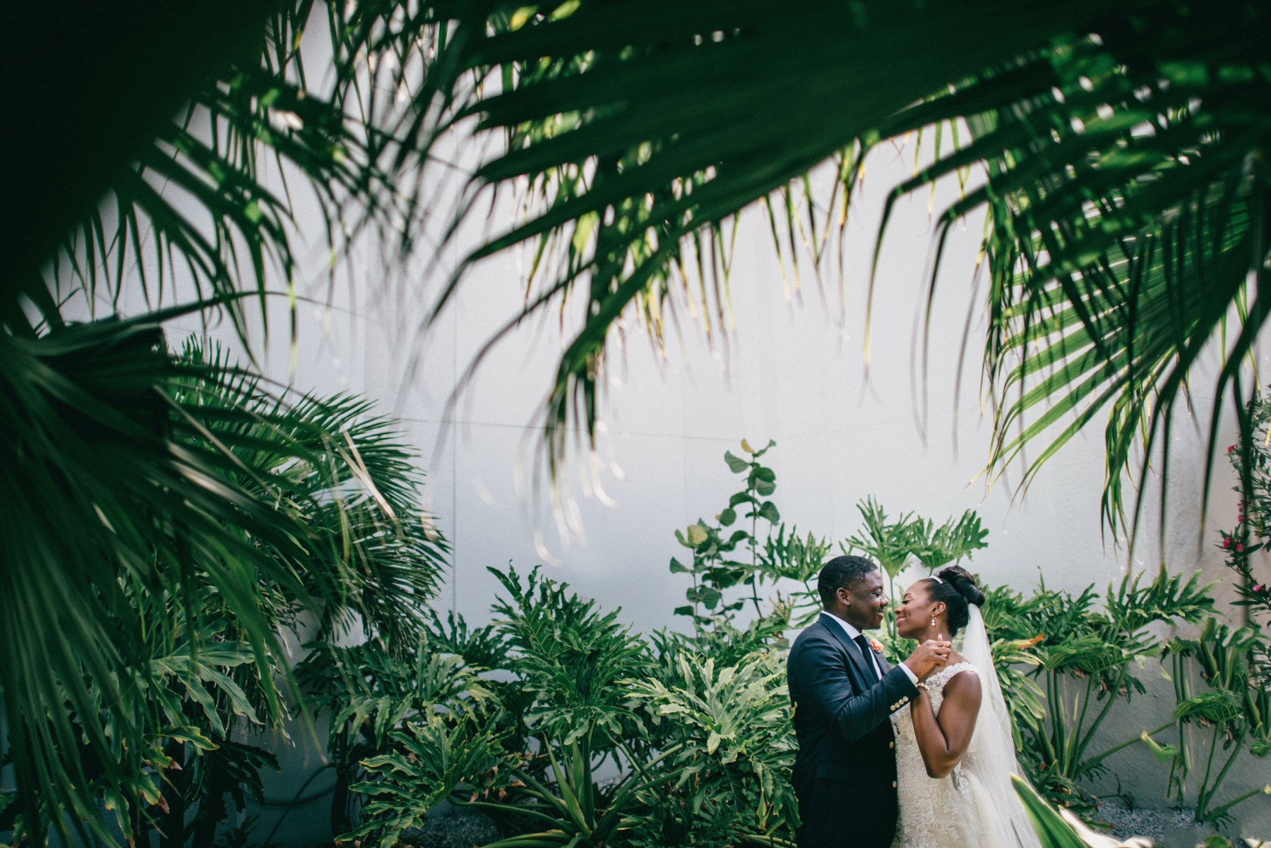 Bride and groom holding hands and smiling at each other