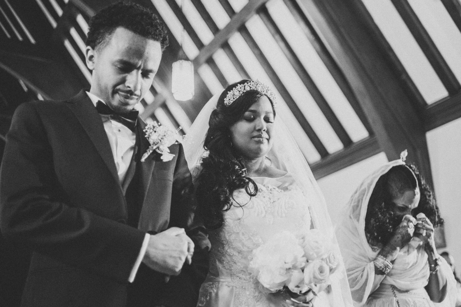 Bride and groom praying together