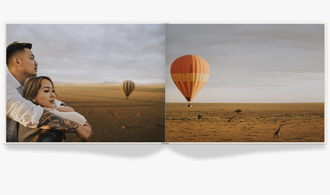 Open photo book with images of couple in Kenya.