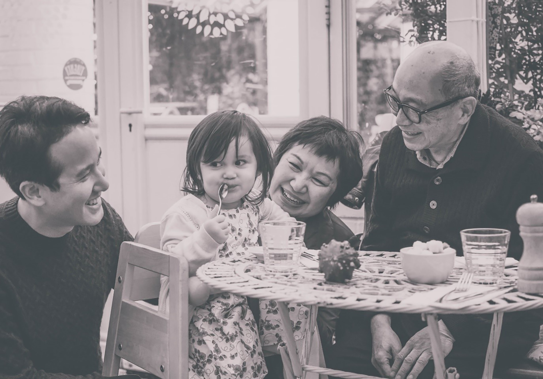 Family laughing sitting around the table.