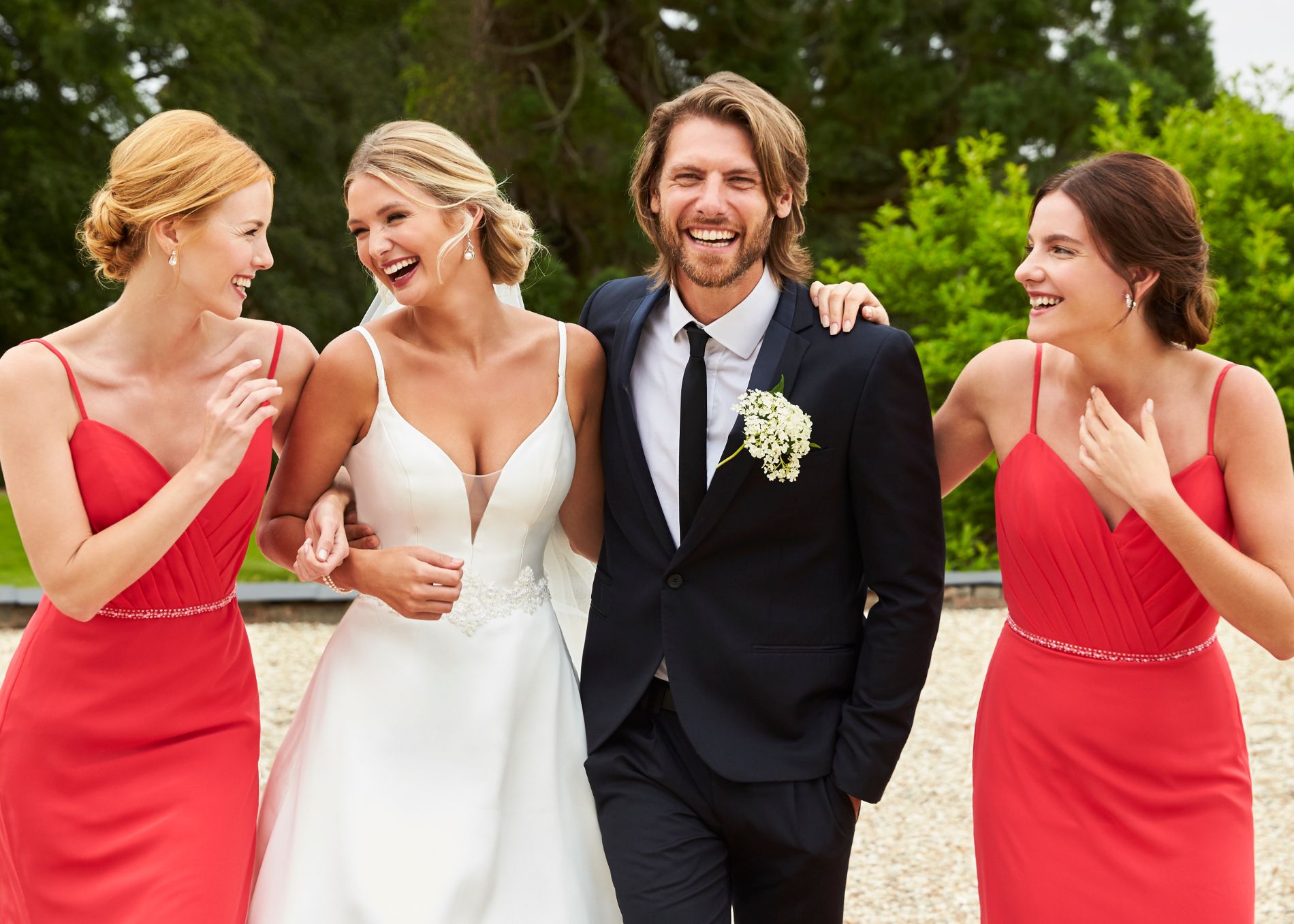 Bride and groom smiling with bridesmaids