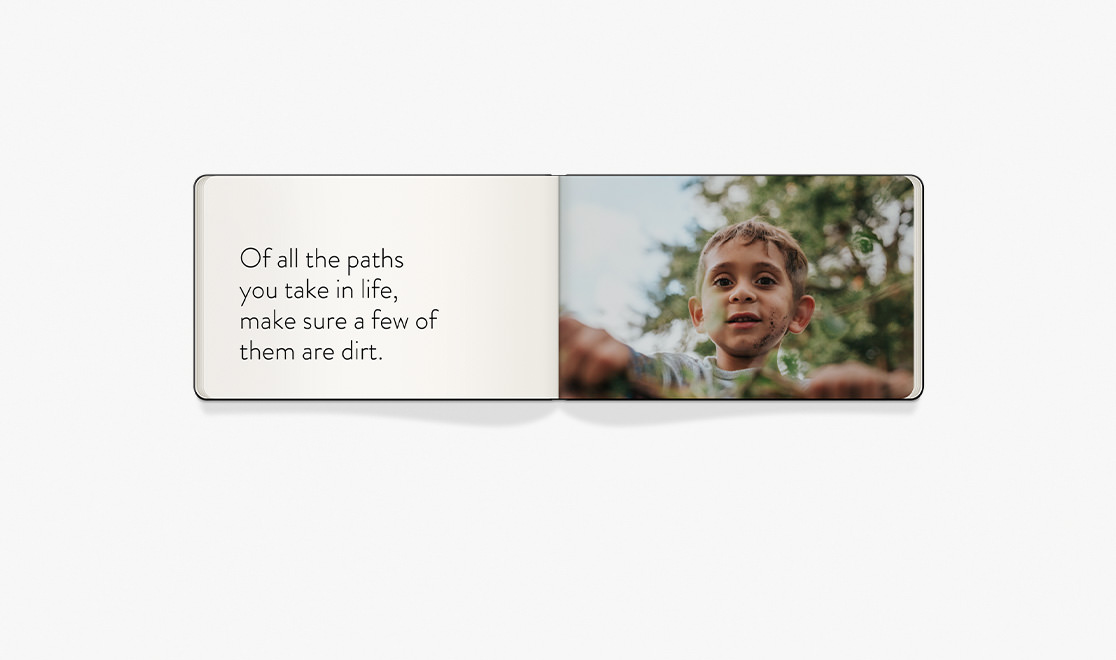 Open Moleskine photo book with text on one page and a closeup of a boy's face on the other.