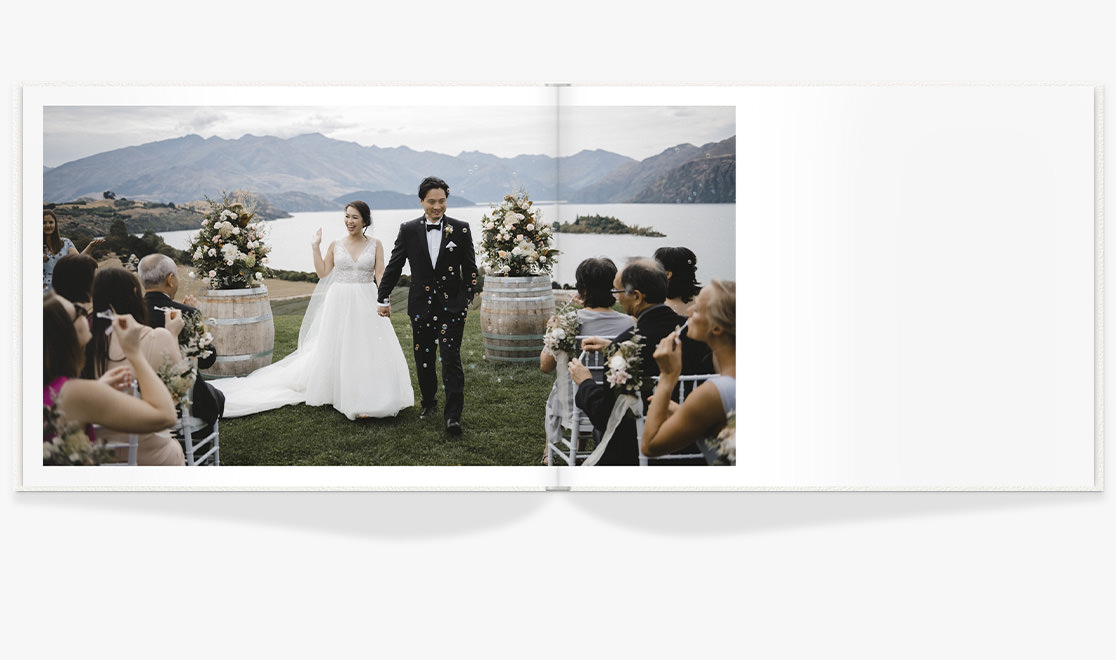 Open Photo Book showing photo of newlyweds walking back down the aisle together