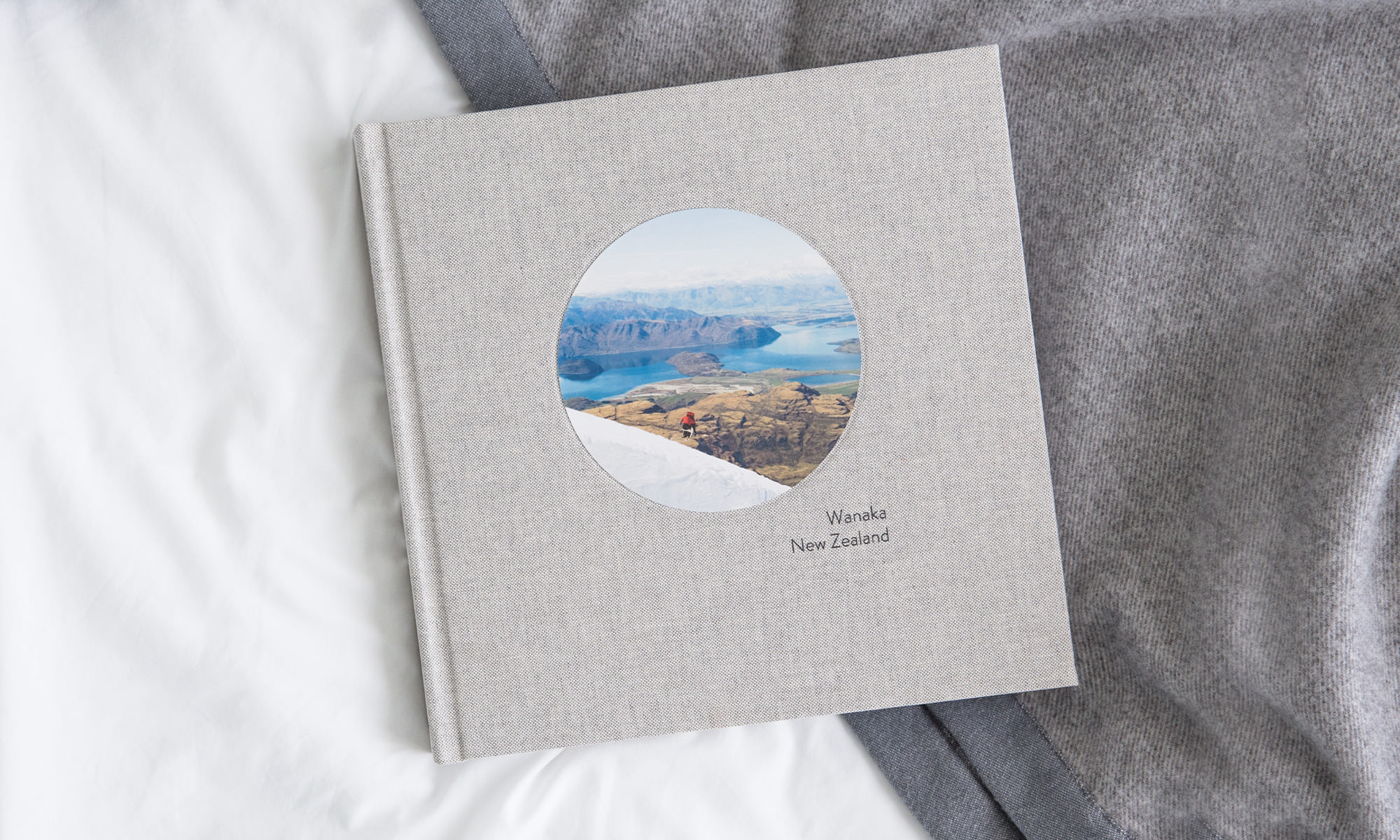 Large square photo book with an image of Wanaka, New Zealand on the cover.