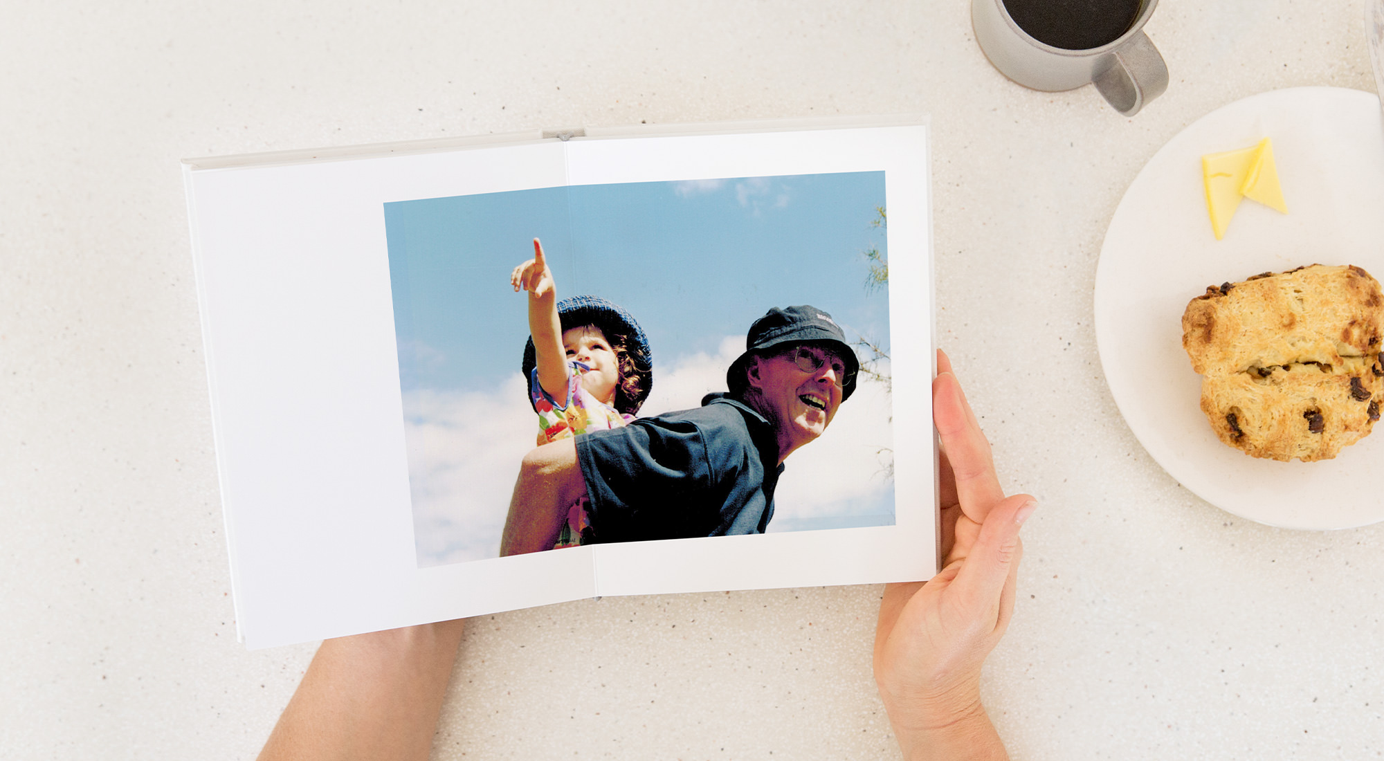Photo book with image of a young girl getting a piggy back from her grandad.
