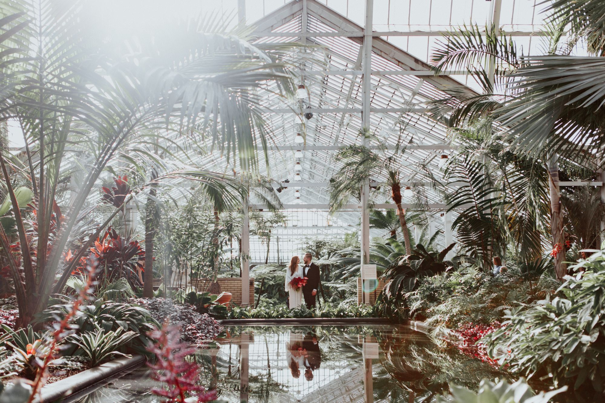 Newlywed wedding portrait at greenhouse.