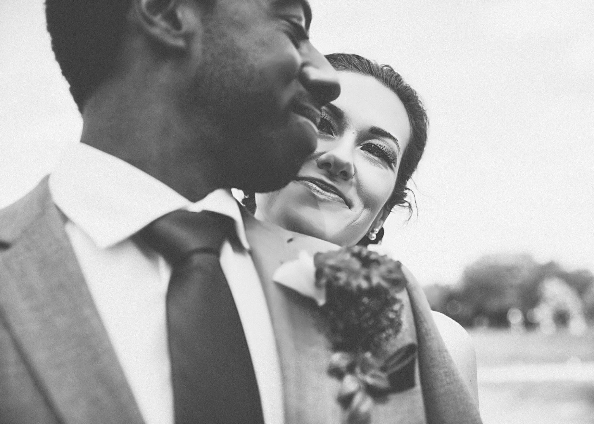 Bride overlooking groom's shoulder.