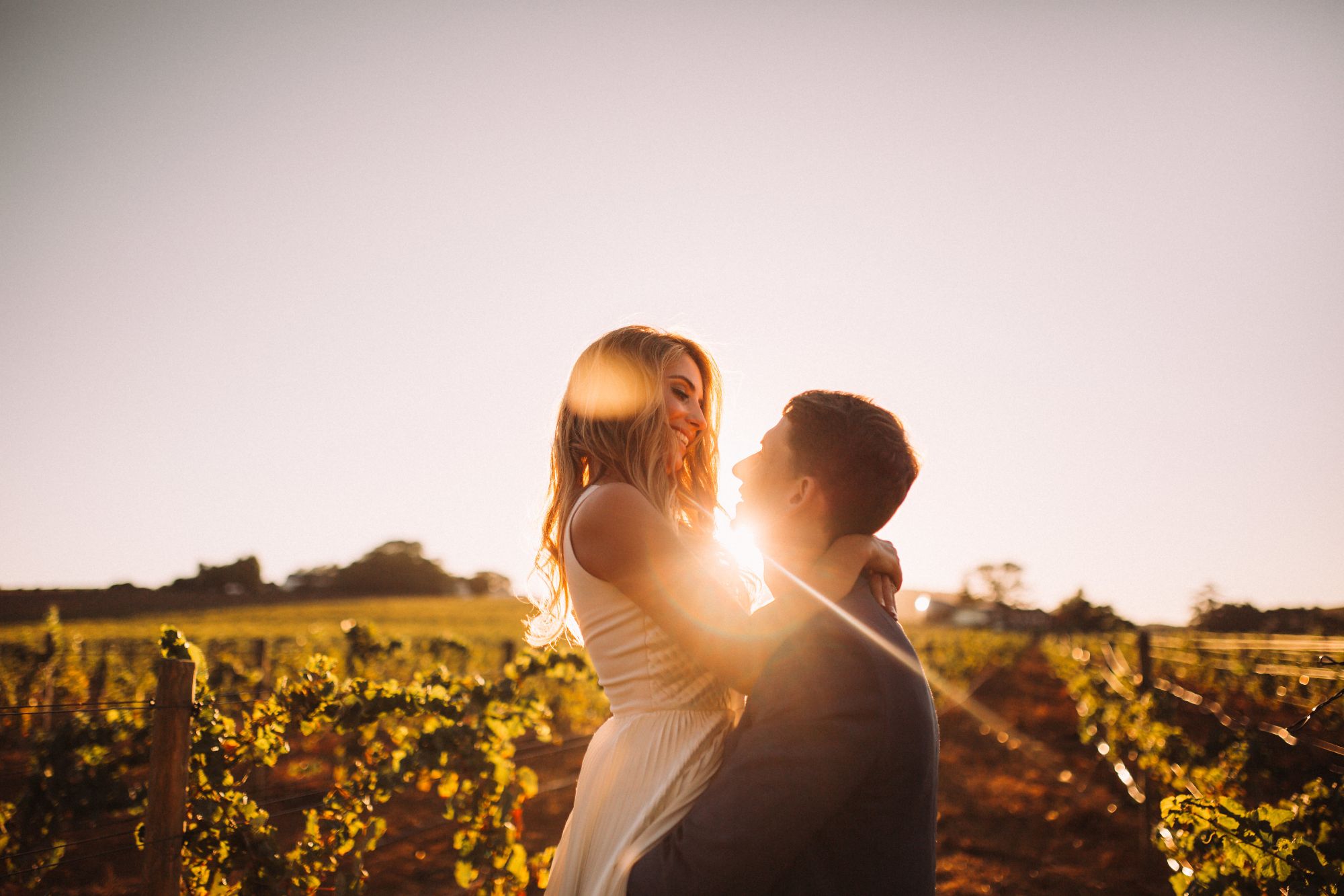 Newlywed couple in vineyard.
