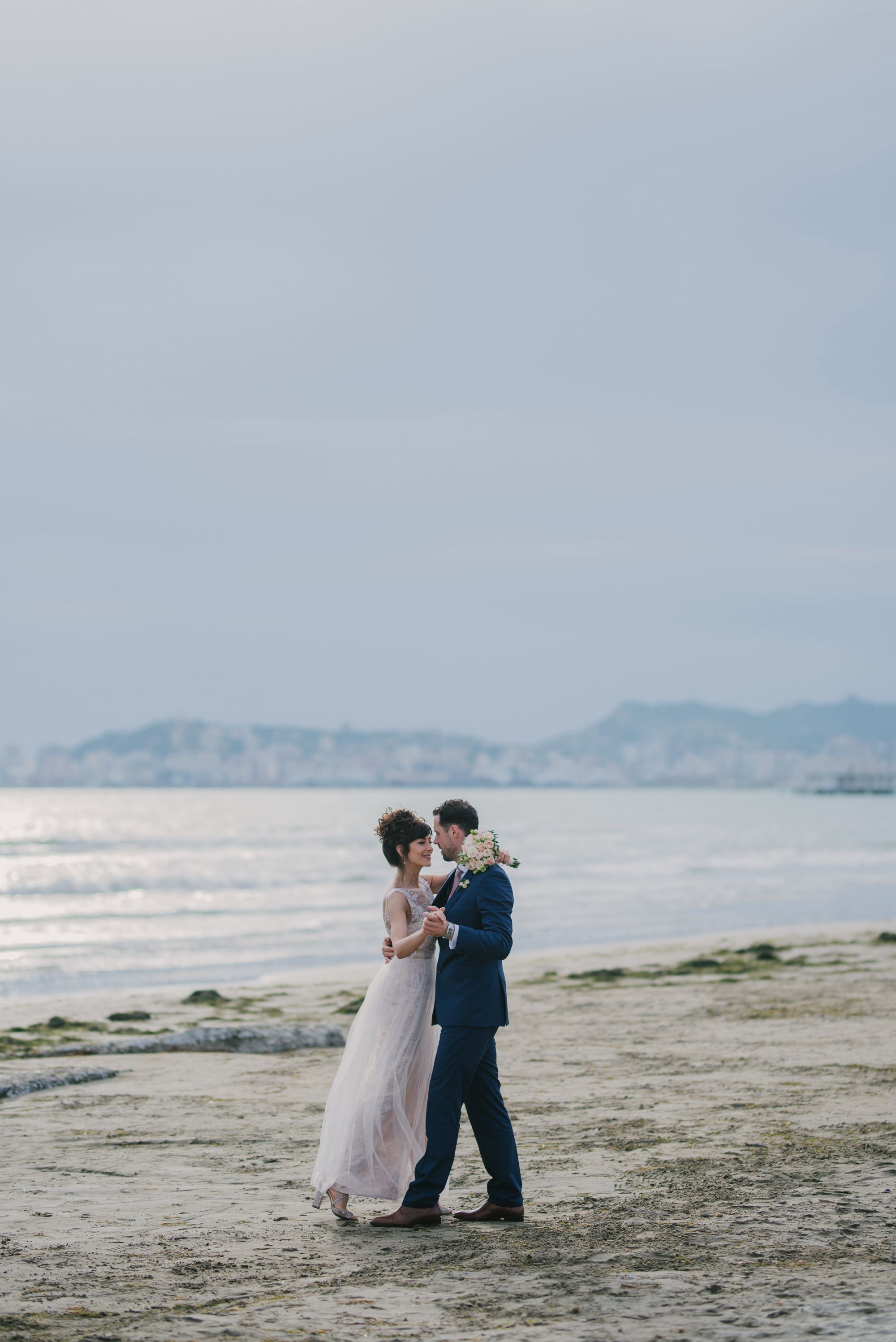 Newlywed bride and groom at the beach.