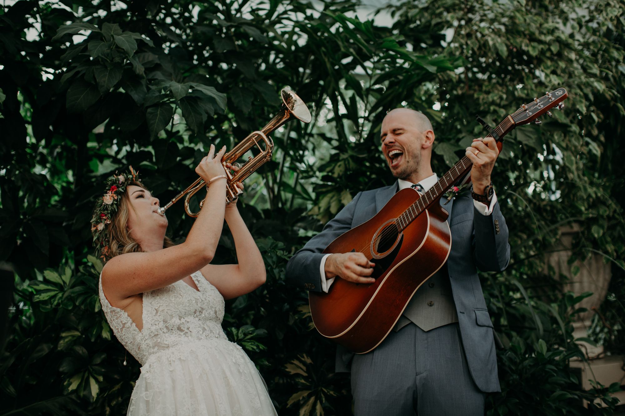 Bride and groom playing trumpet and guitar.