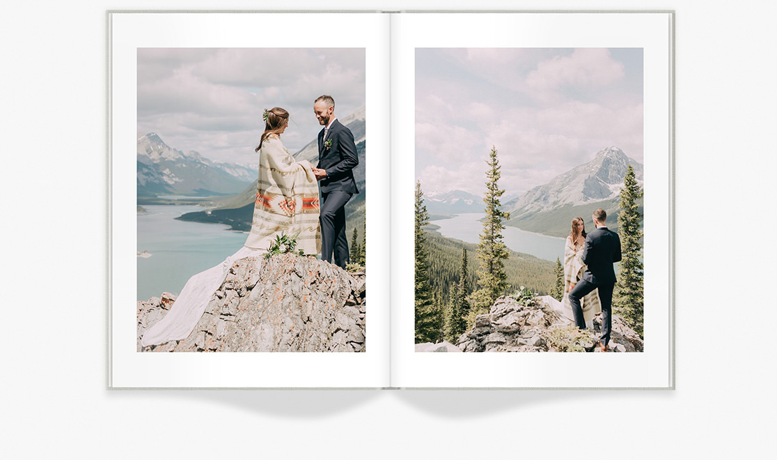 Open photo book portraits of a newlywed couple on a mountaintop.