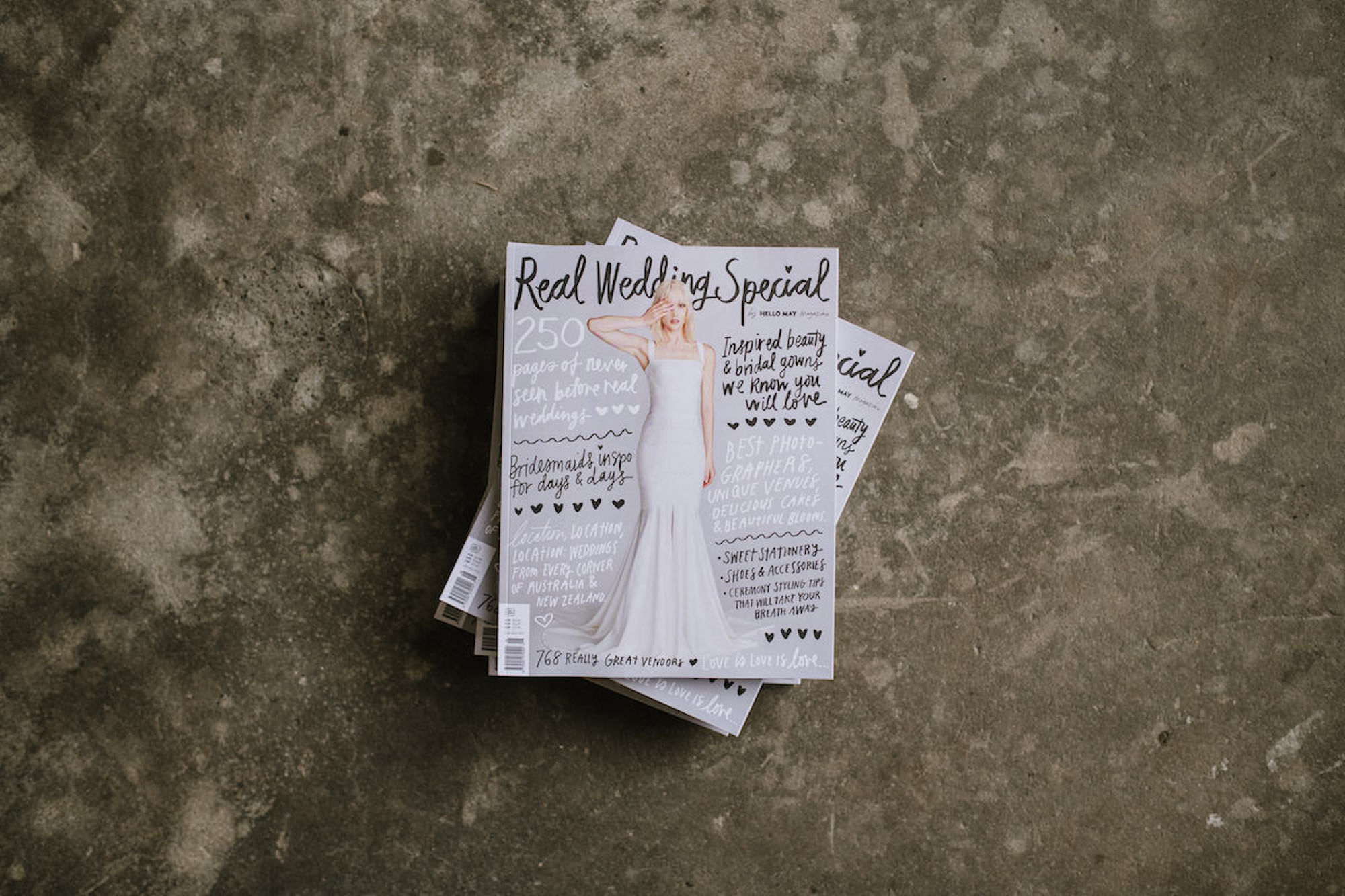 Stack of magazines on a grey concrete surface