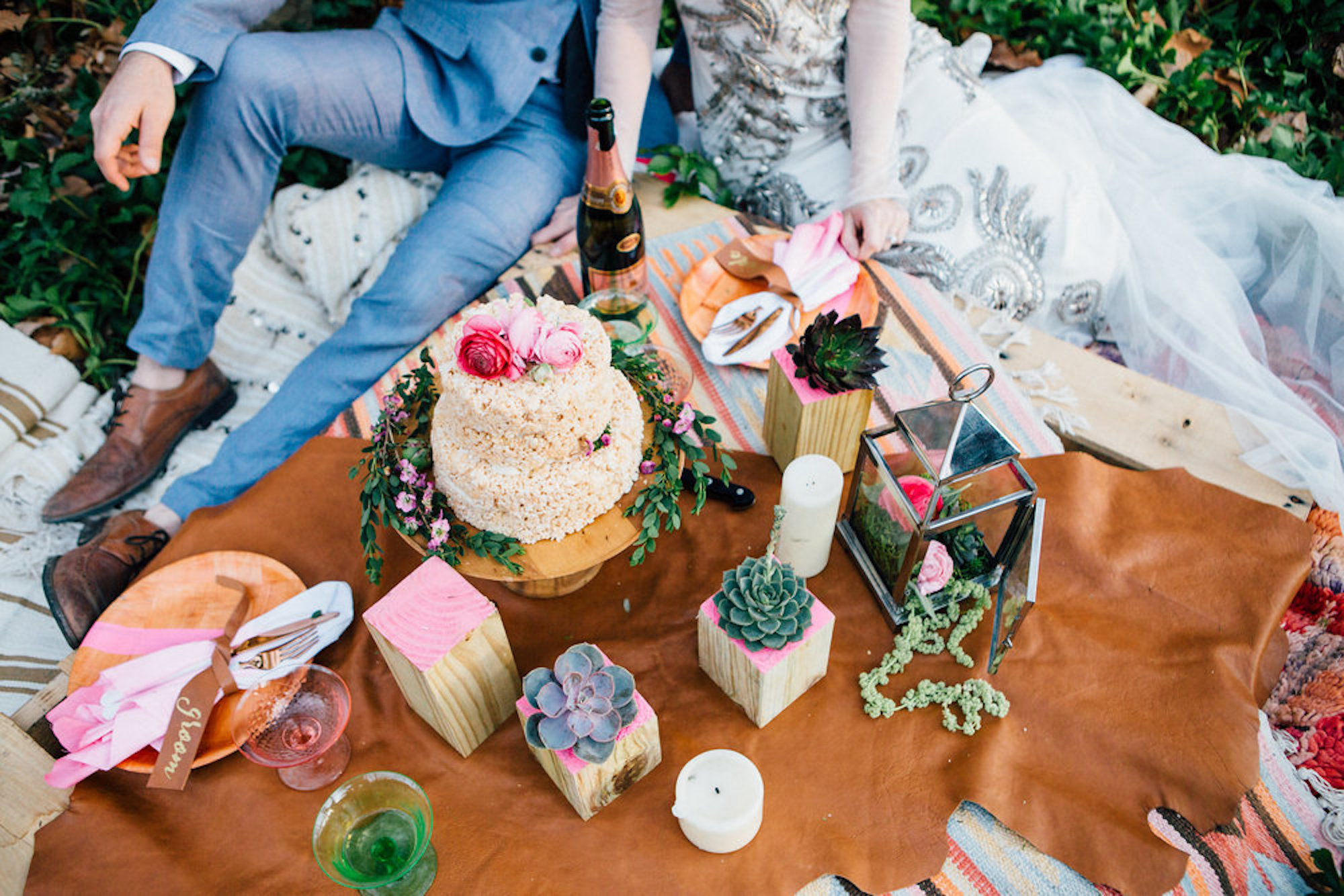 Bride groom with wedding cake on a picnic rug