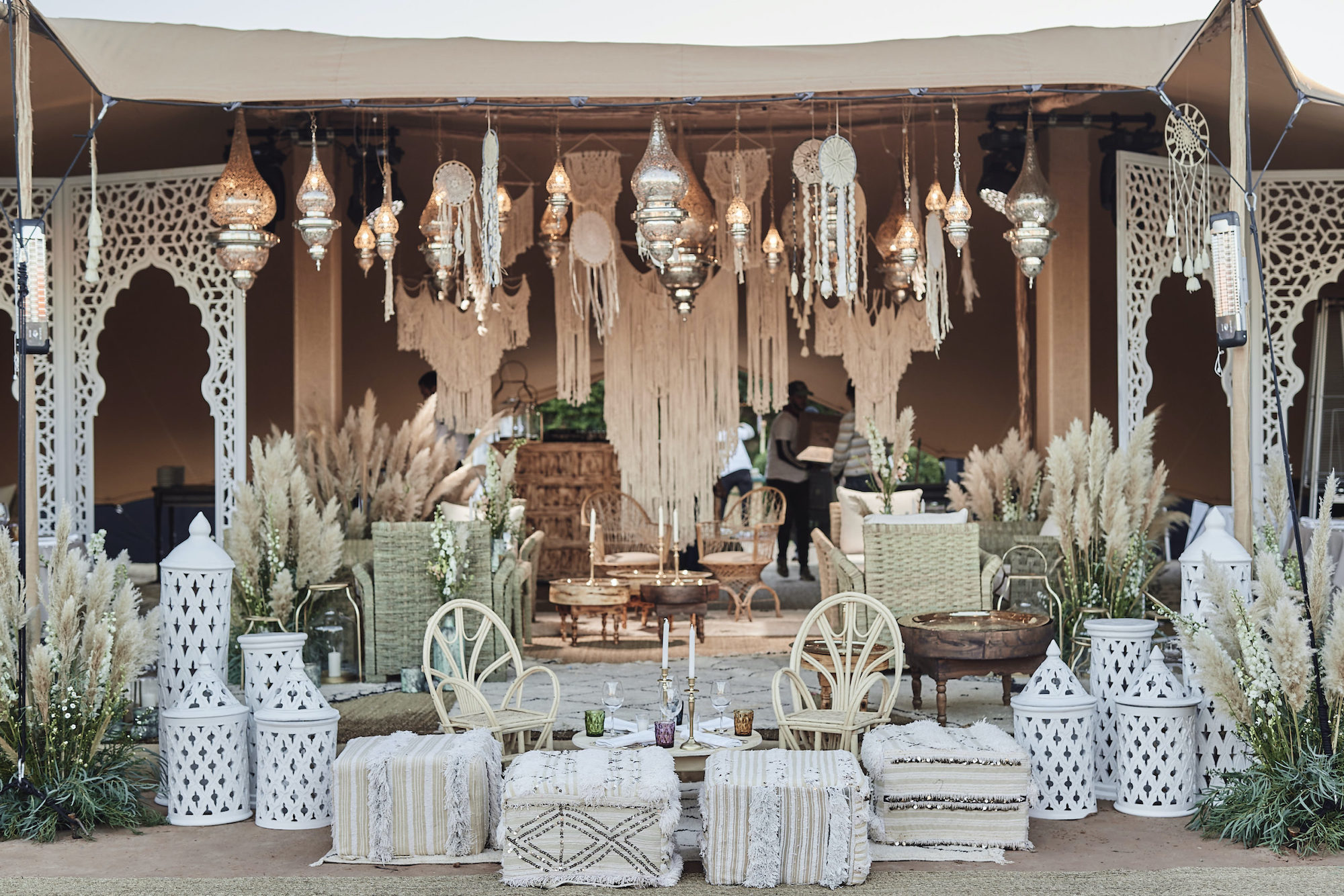 Bohemian style outdoor setting with lanterns, candles and pampas grass