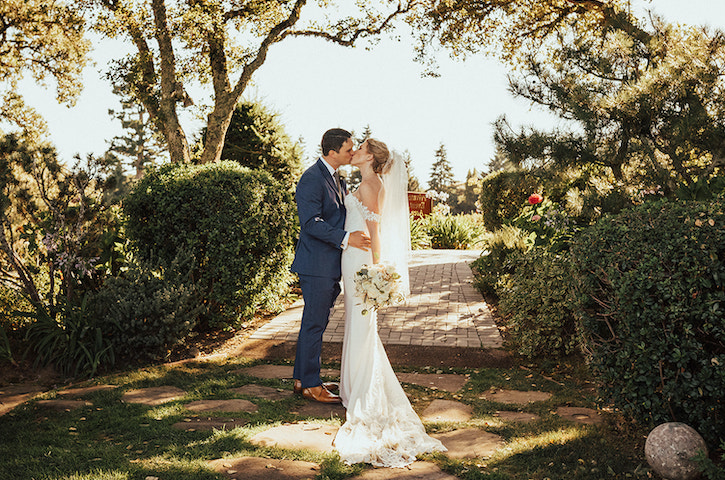 Newlyweds kiss in trees