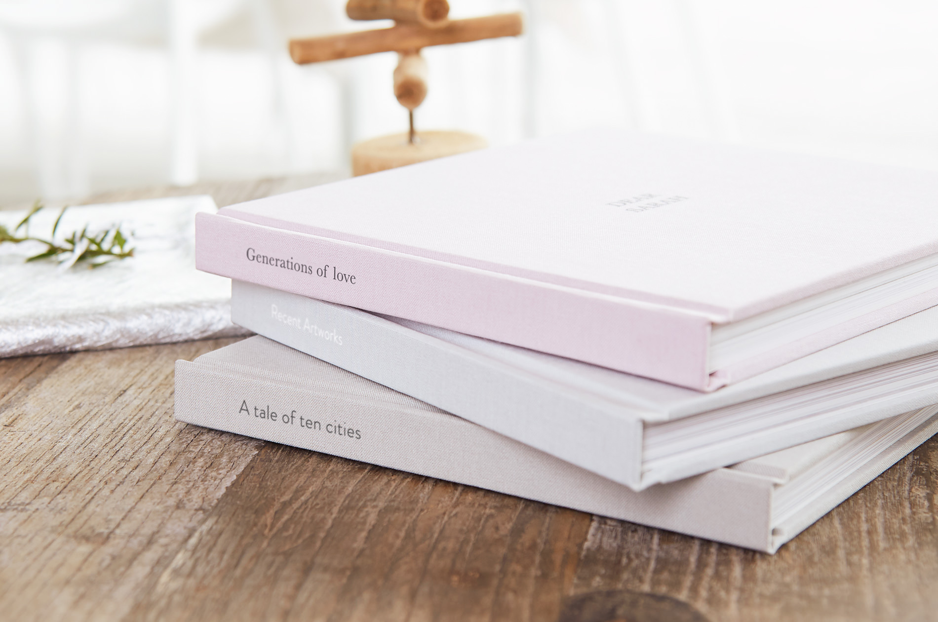 Three Premium Photo Books stacked atop each other