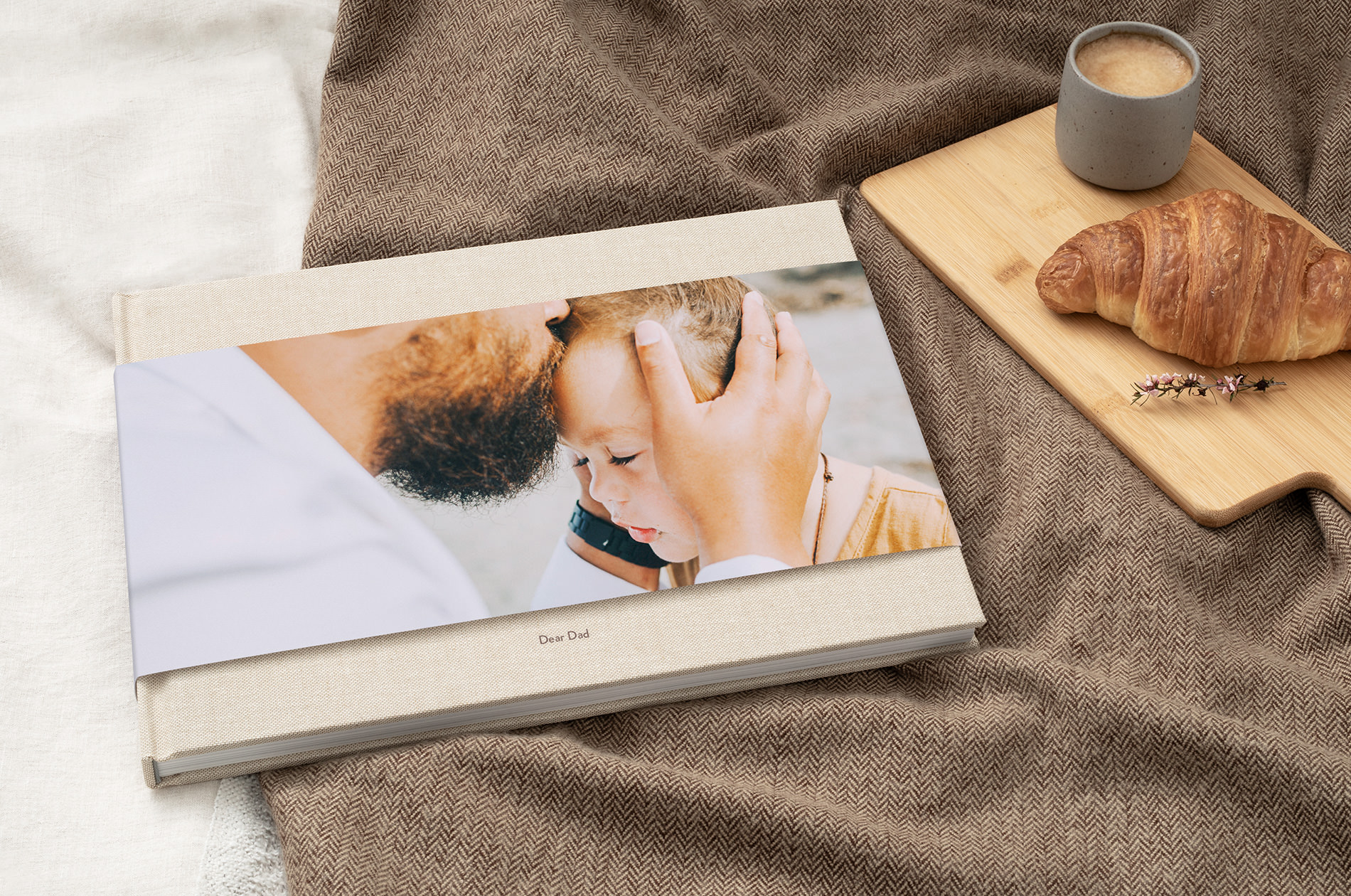 Premium Large Landscape Photo Book with partial jacket on cover showing father kissing son on forehead