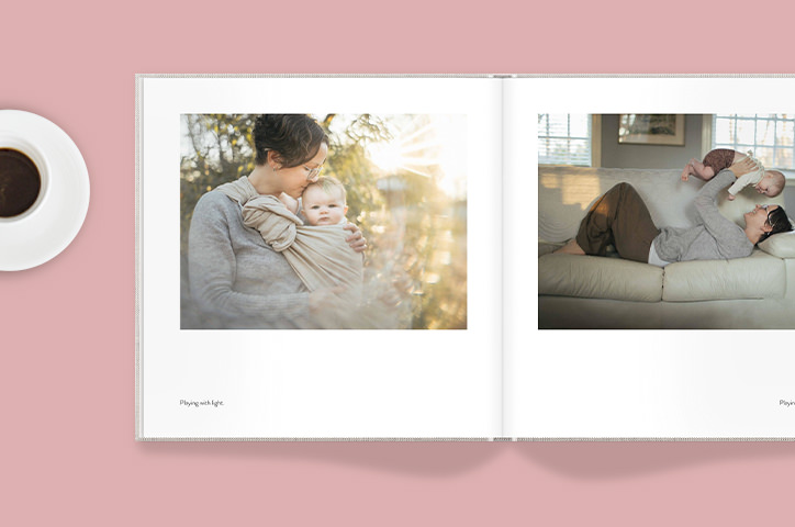 Open photo book on a pink background with images of a woman and baby.