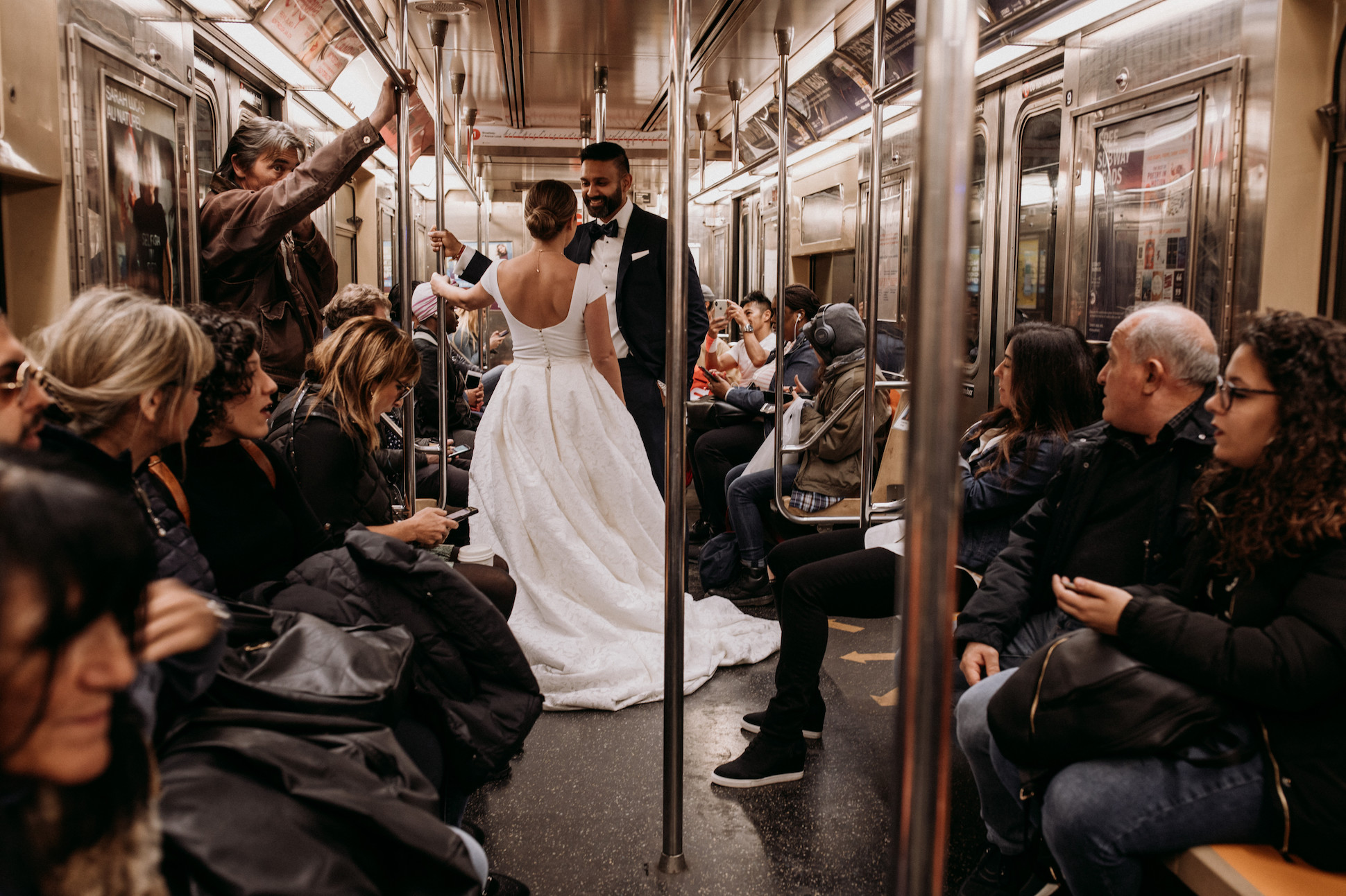 Bride and groom in crowded subway